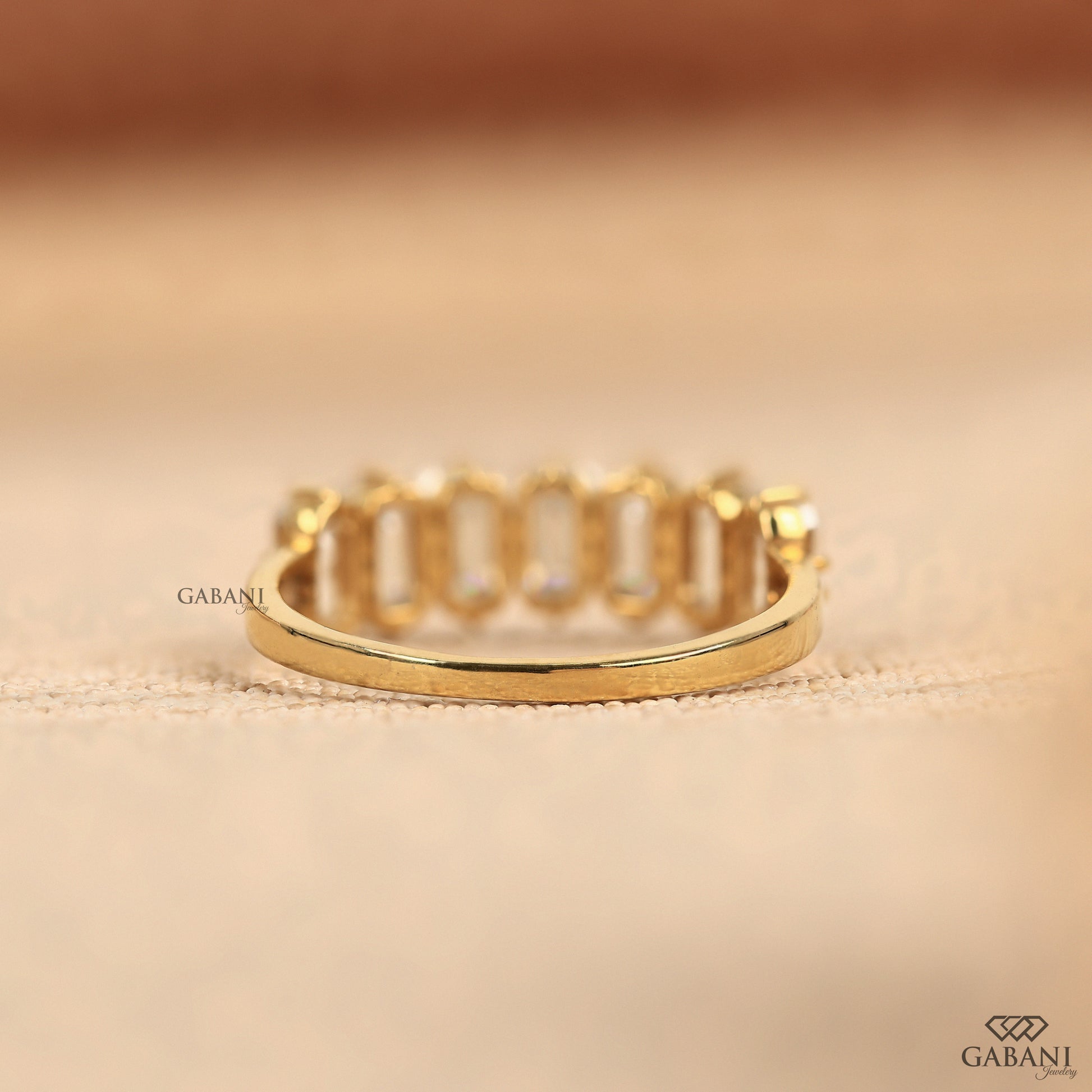 Seven stone emerald cut diamond band crafted with certified lab grown diamonds in yellow gold