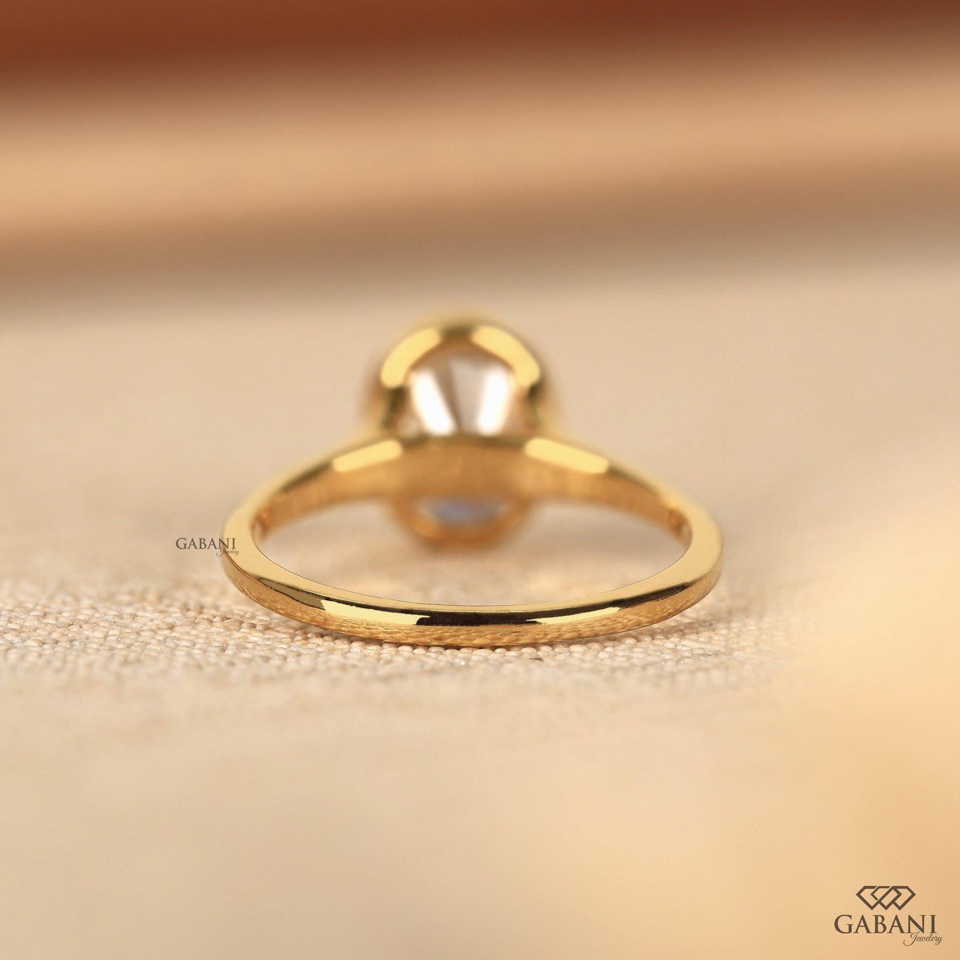 Minimal oval bezel set lab grown diamond ring with smooth shank