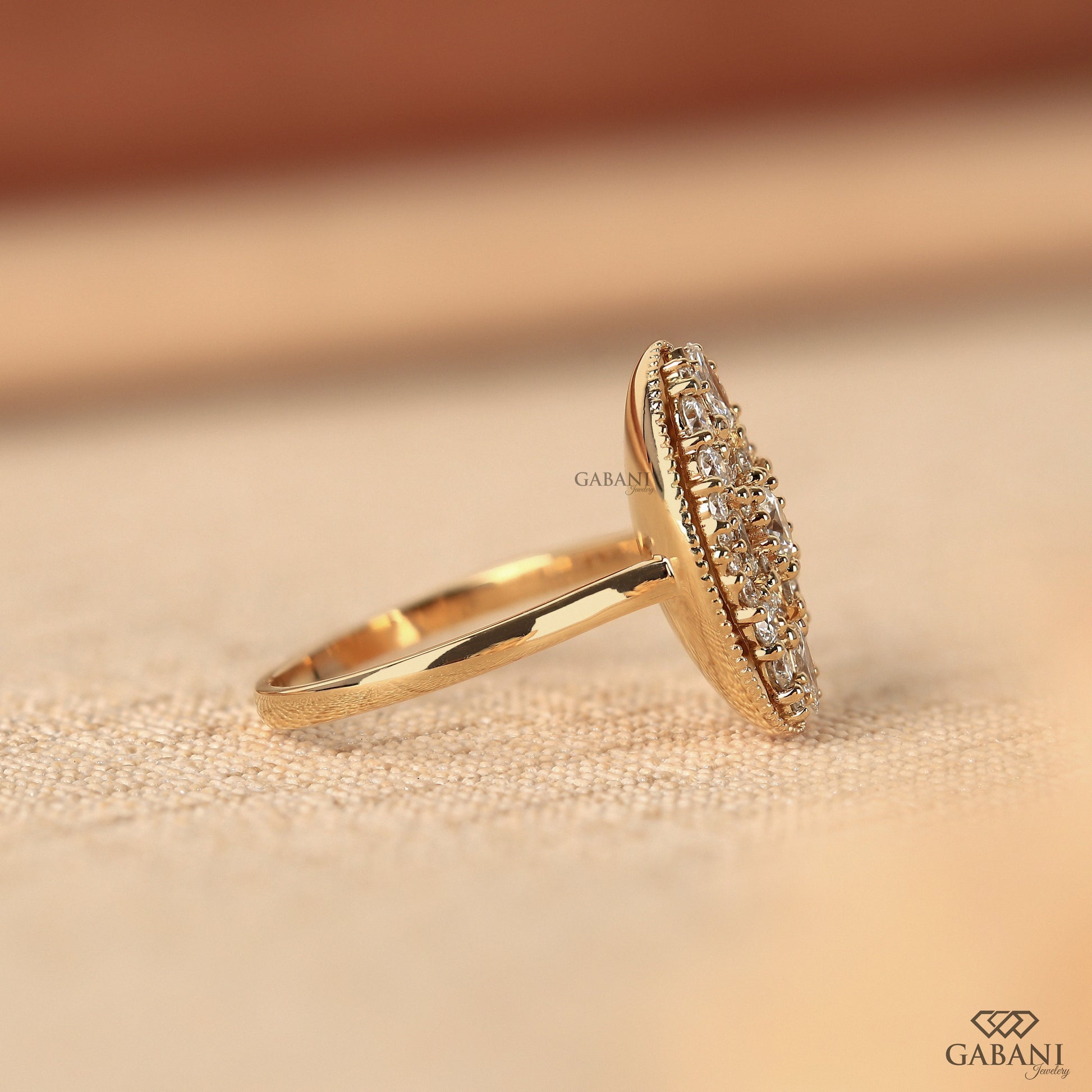 Yellow gold oval mosaic diamond ring with button prong setting
