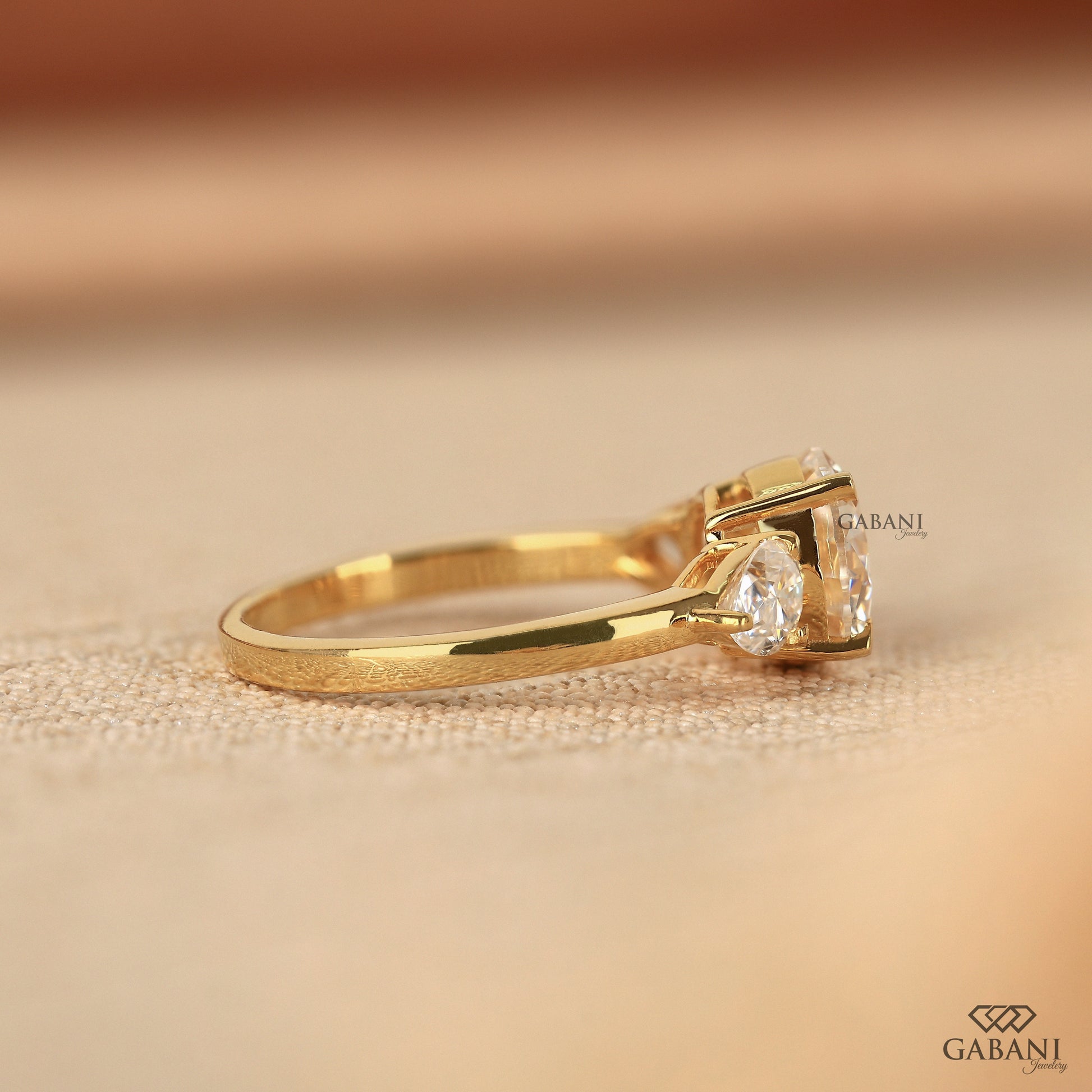round cut lab grown diamond three stone ring with prong setting in 14k yellow gold