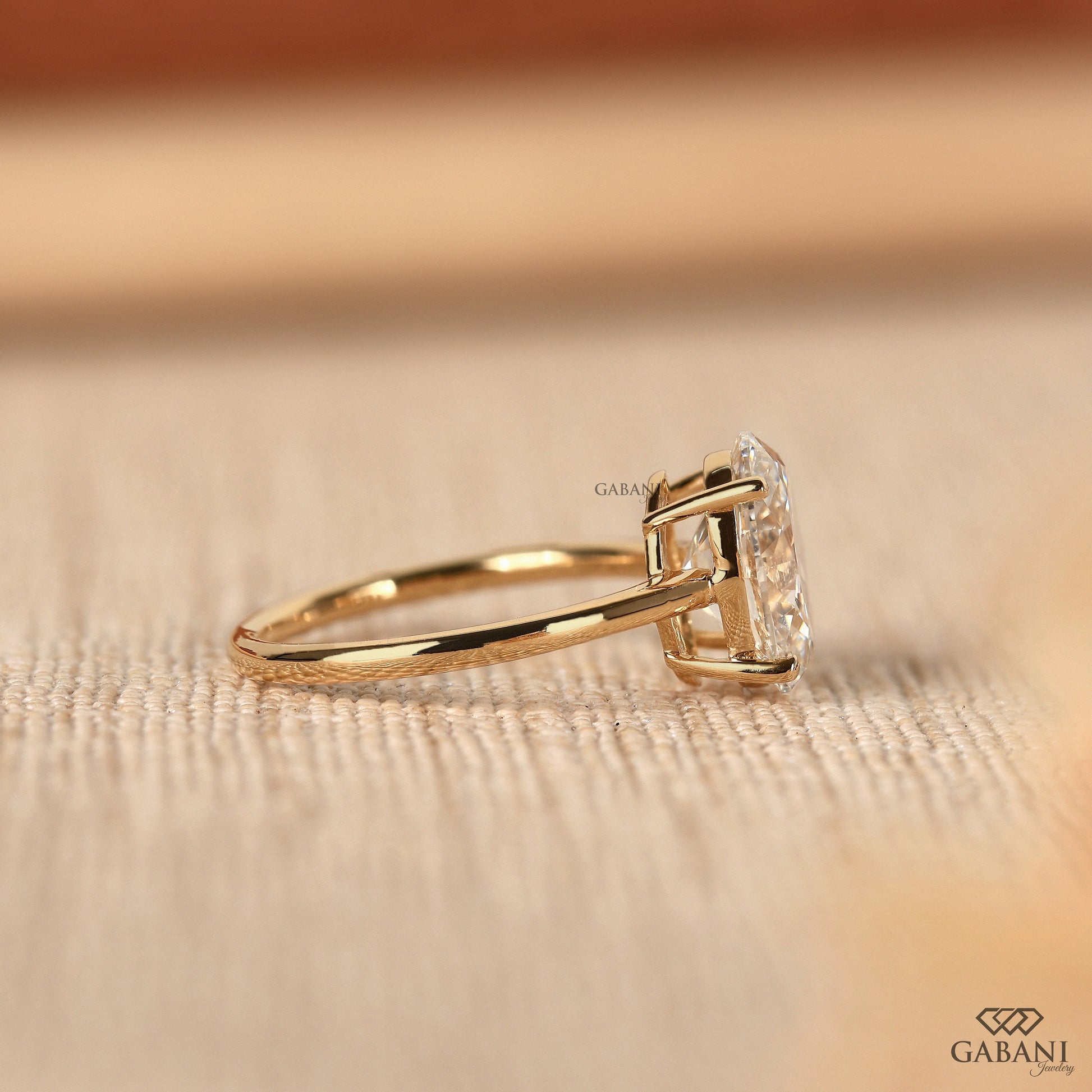 oval lab grown diamond solitaire ring in yellow gold with secure prong setting