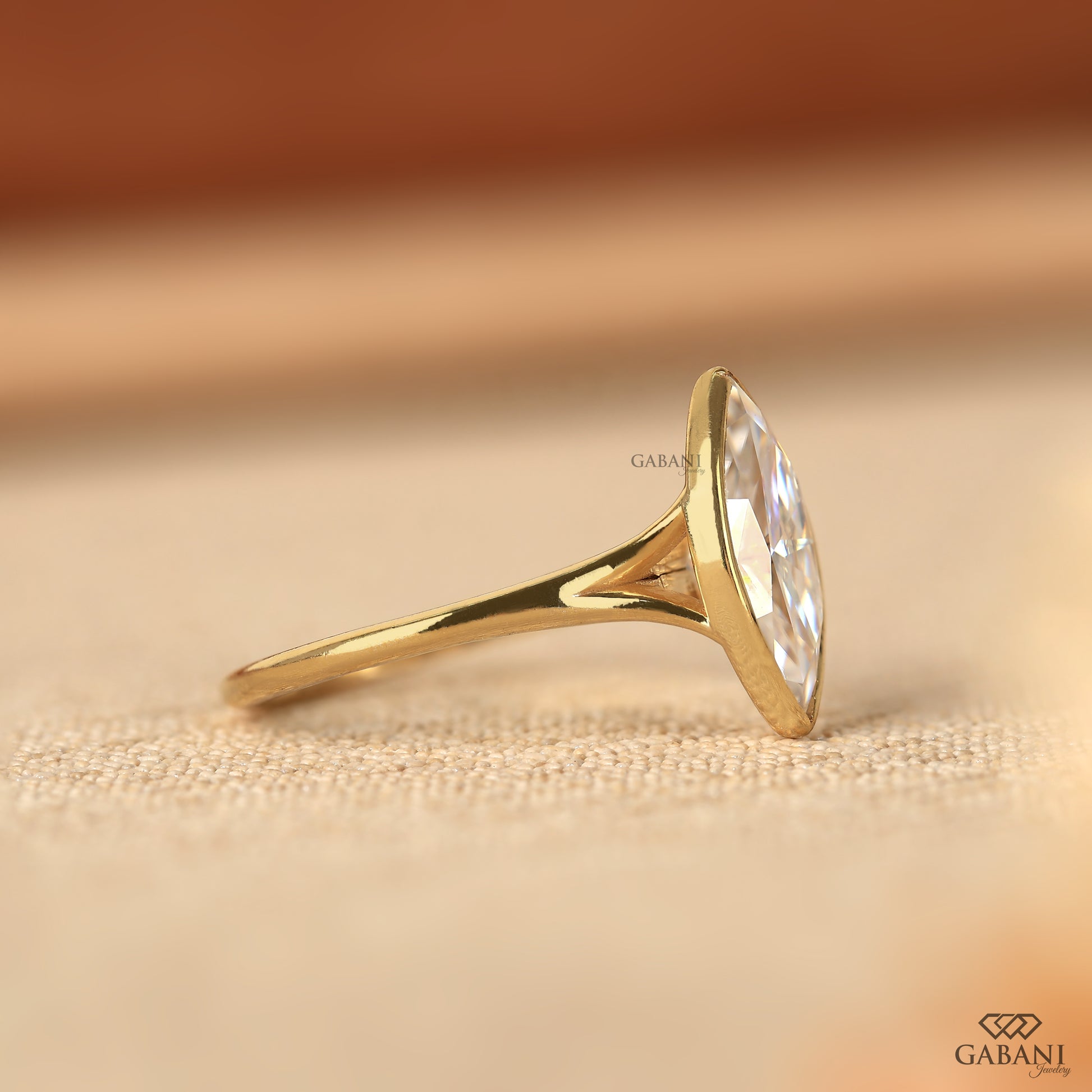 Modern marquise lab grown diamond engagement ring with split shank and bezel