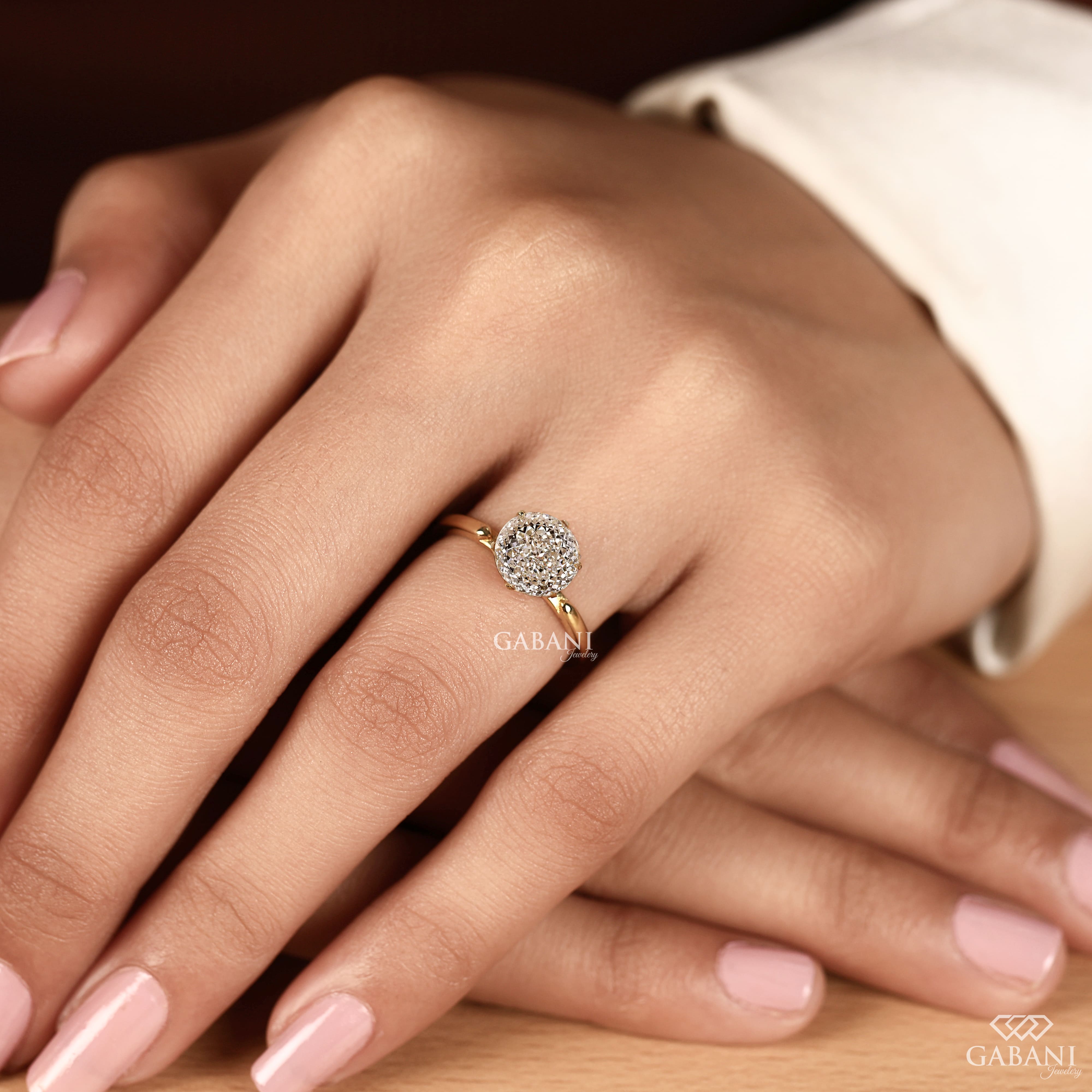 Round Portuguese cut lab grown diamond solitaire engagement ring in yellow gold with a six-prong tulip basket and polished plain band.