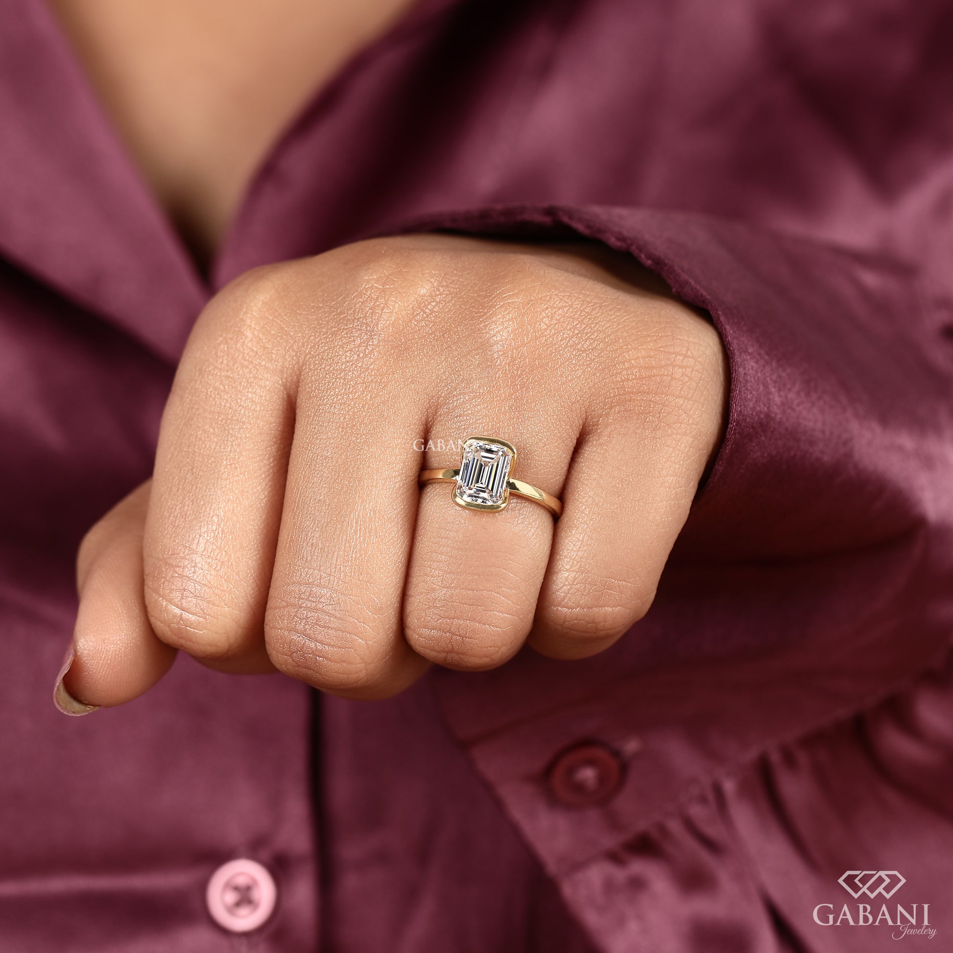 sleek emerald cut lab grown diamond ring with architectural half bezel setting