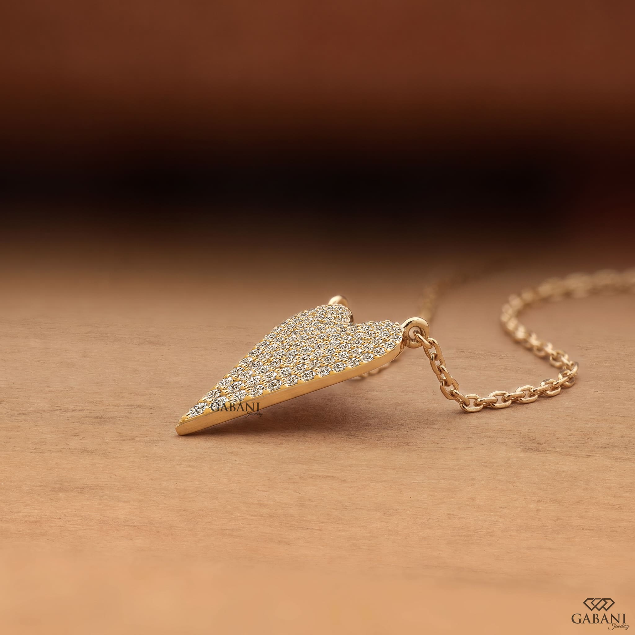 Heart shaped lab grown diamond pendant necklace in yellow gold with sparkling round cut diamonds and a delicate cable chain.