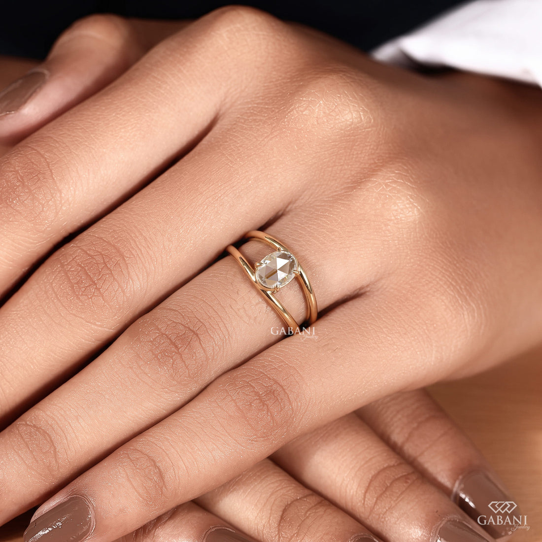 Oval rose cut lab grown diamond engagement ring with prong setting, open split shank design and polished yellow gold band.