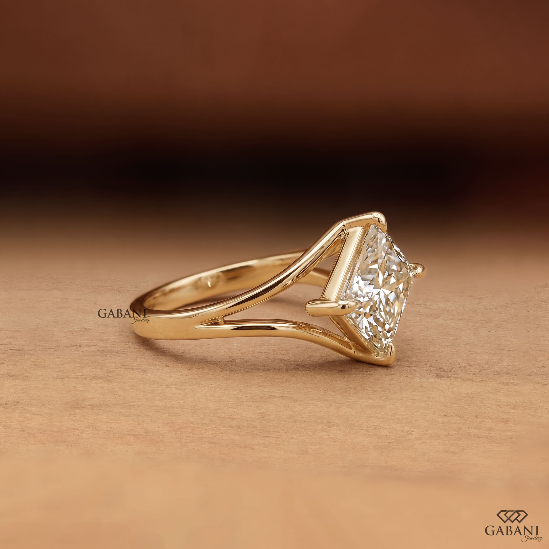 Princess cut lab grown diamond engagement ring in yellow gold featuring a kite set center stone, four prong setting, and modern open split shank design.