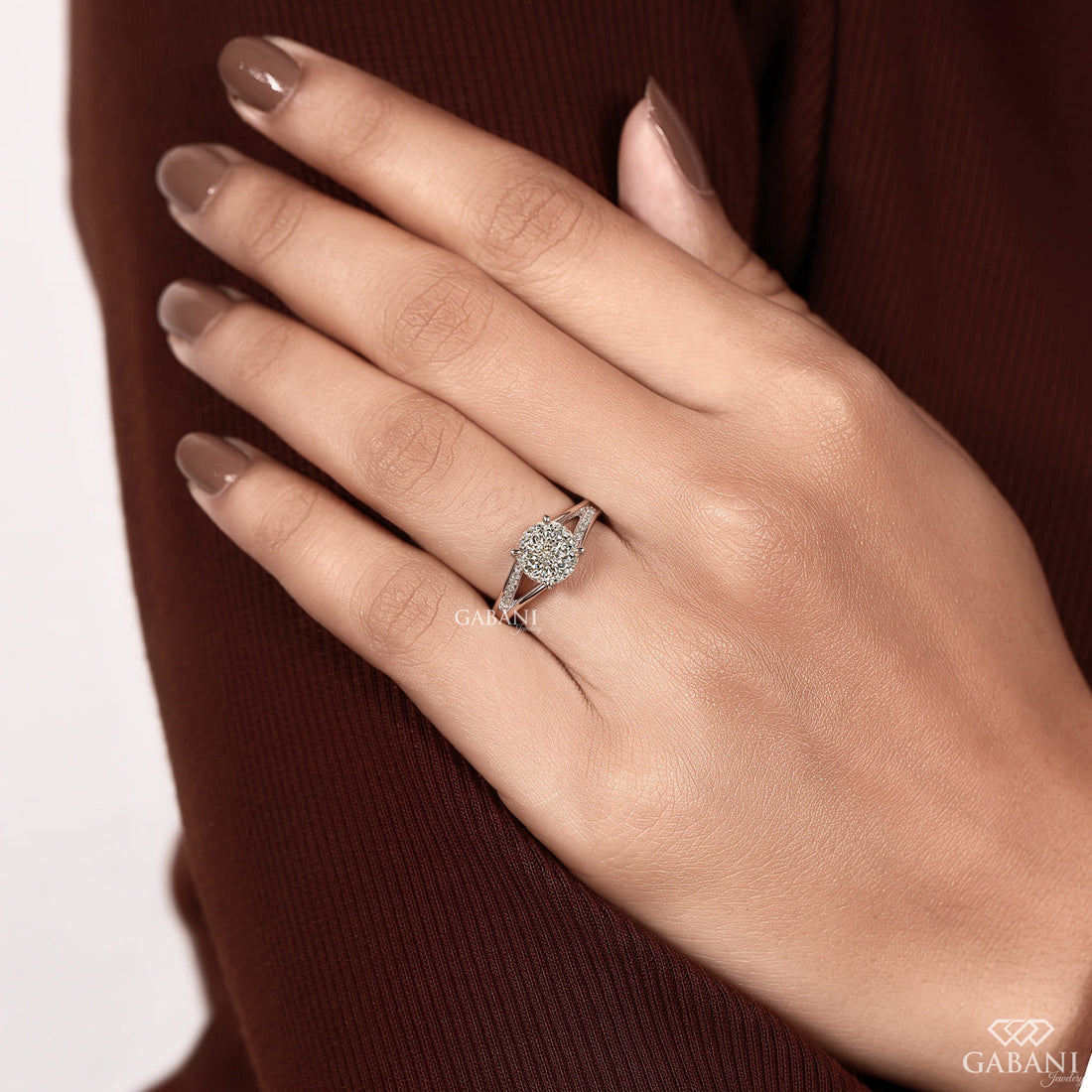 Round cut lab grown diamond engagement ring with split shank, pavé side stones, four-prong setting, and polished white gold band.