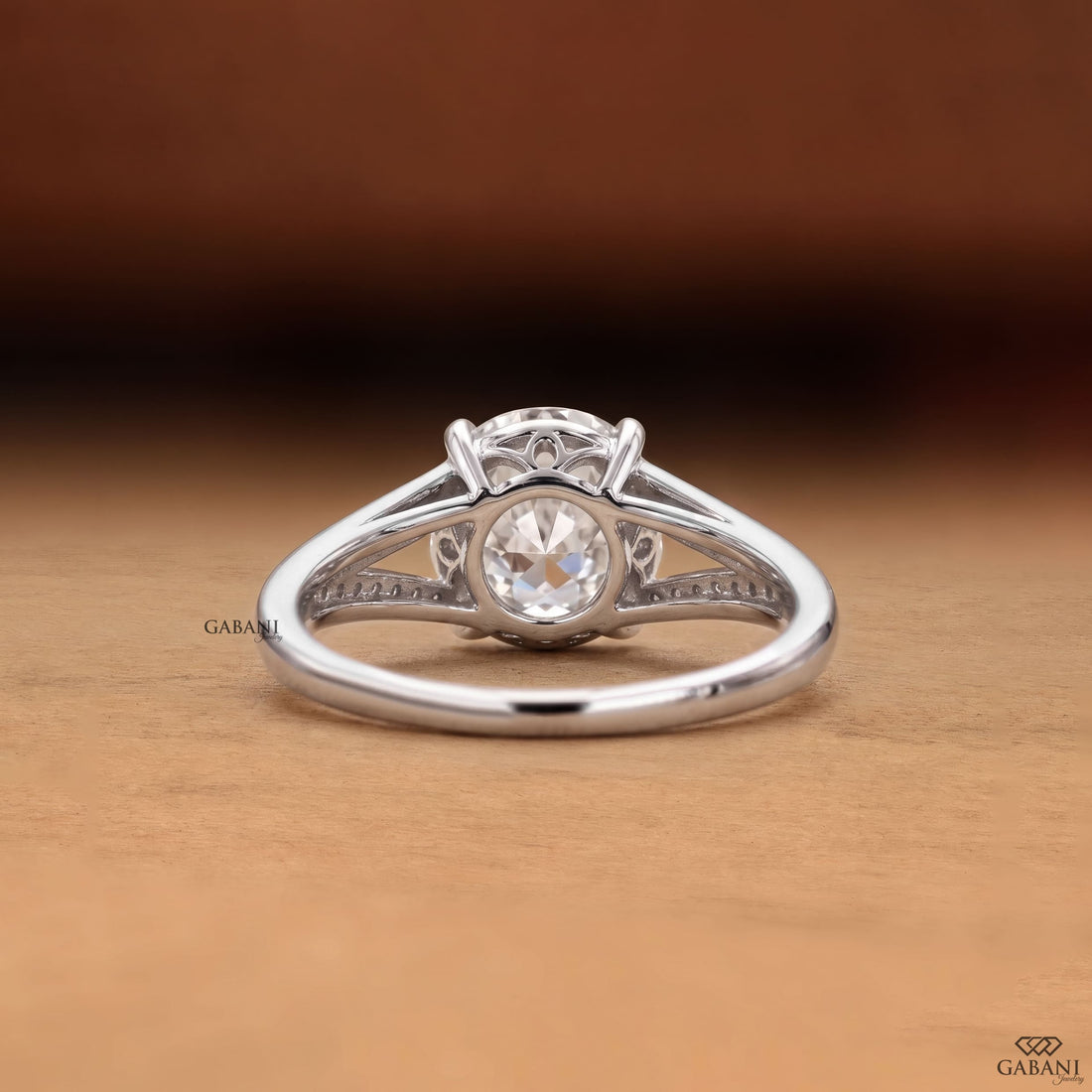 Round cut lab grown diamond engagement ring with split shank, pavé side stones, four-prong setting, and polished white gold band.