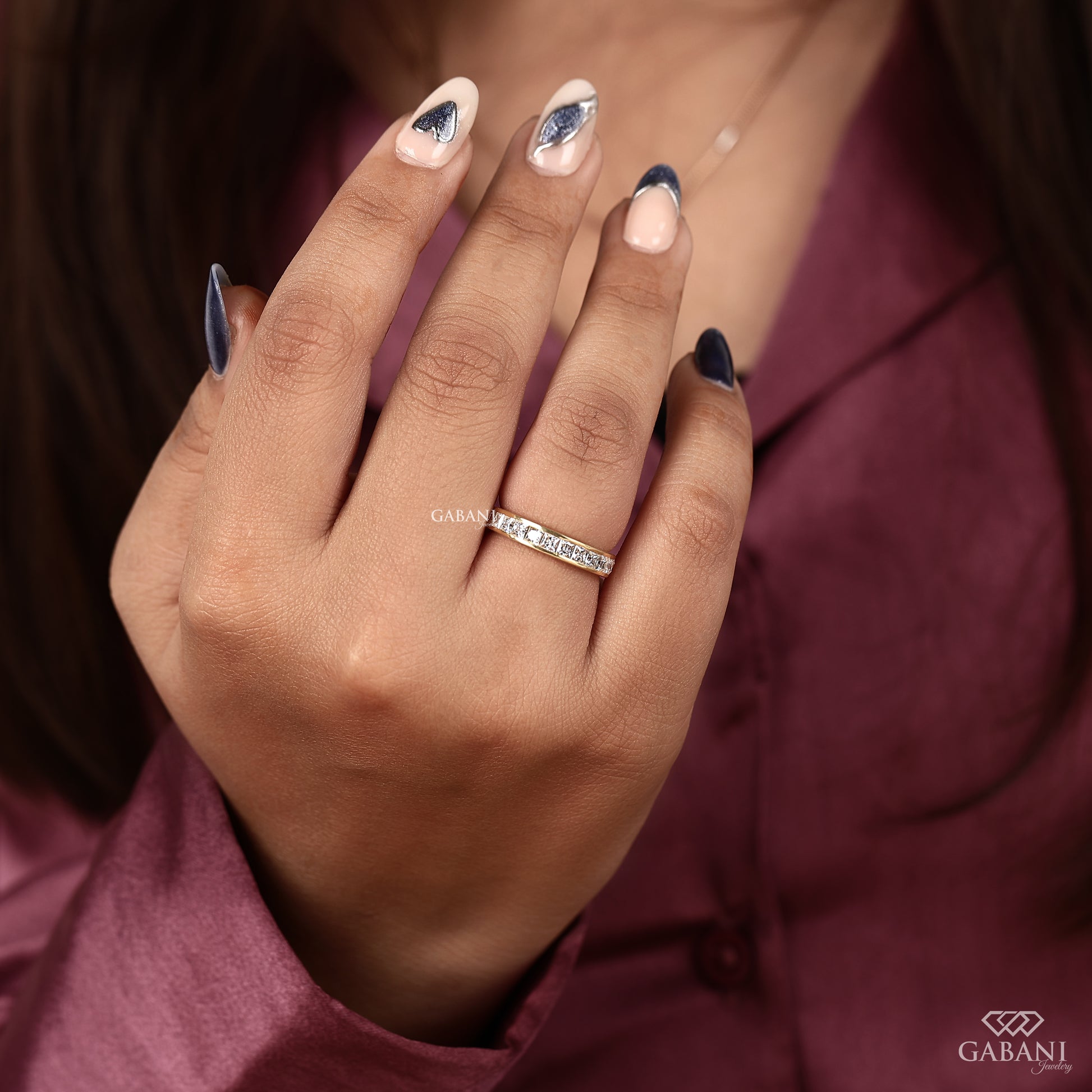 Yellow gold wedding band featuring channel set princess cut lab grown diamonds