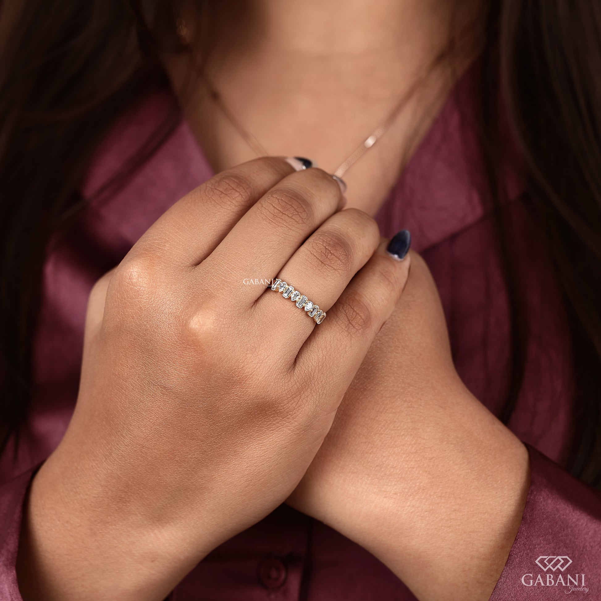 yellow gold diamond band with emerald cut and pear cut lab grown diamonds
