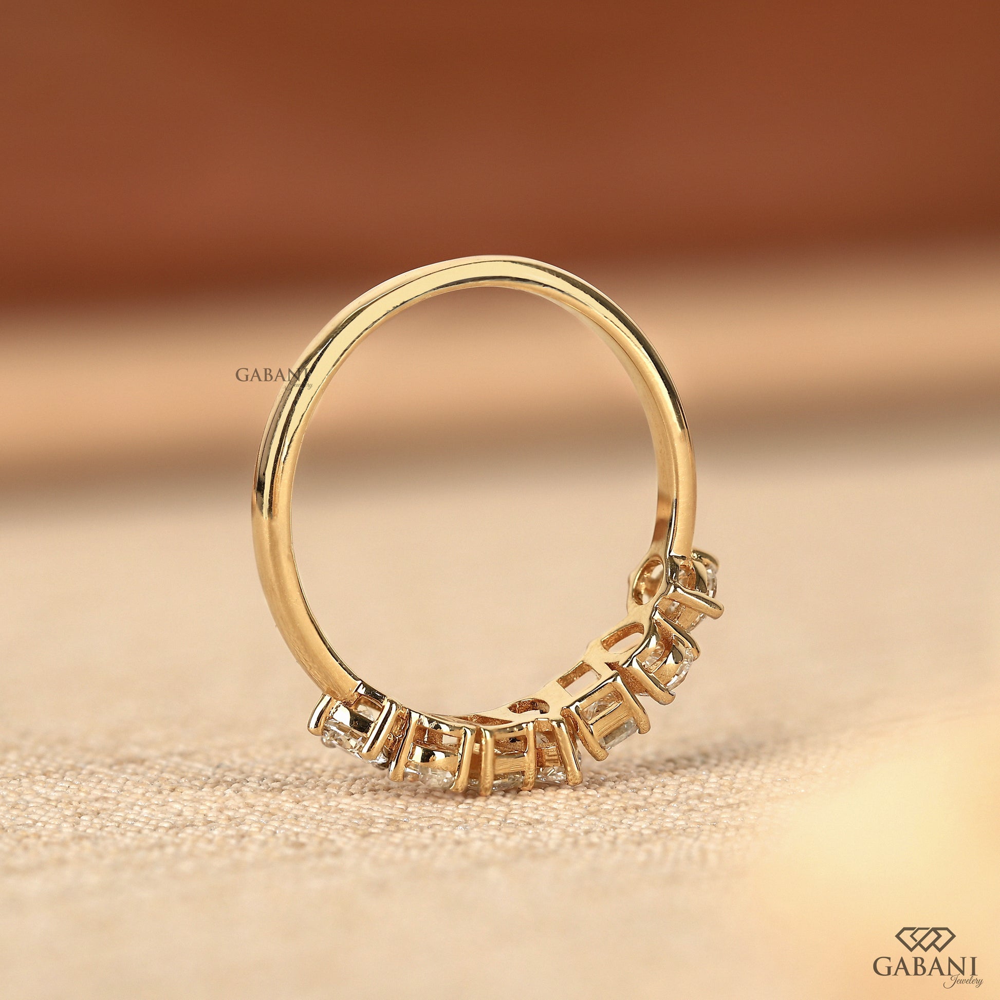 Stackable wedding band featuring emerald pear and round lab grown diamonds