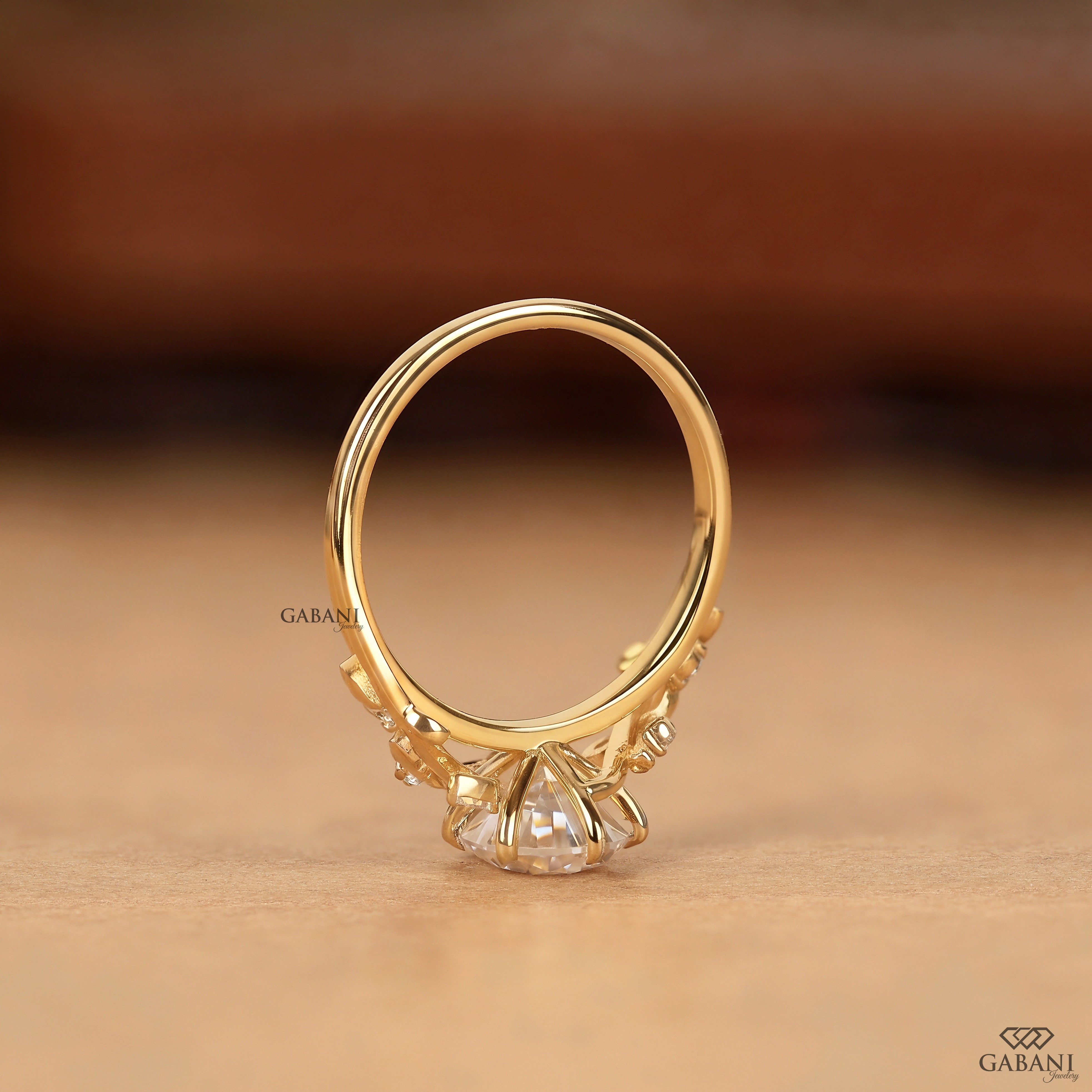 Standing view of nature inspired pear cut lab grown diamond engagement ring