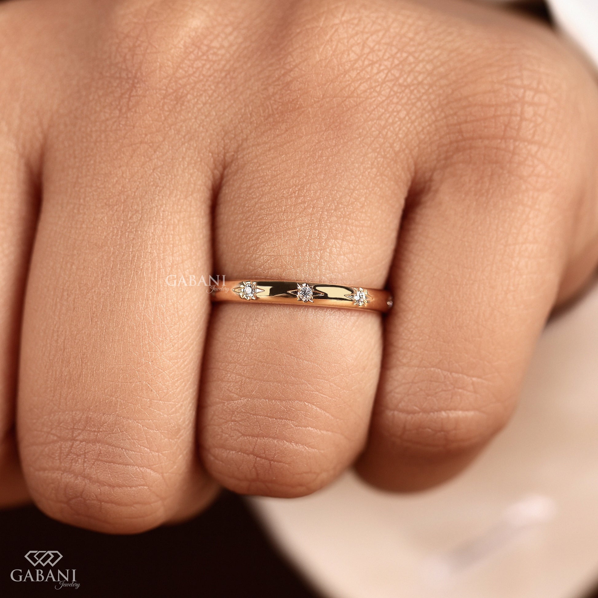 thin yellow gold band with scattered flush set lab grown diamonds
