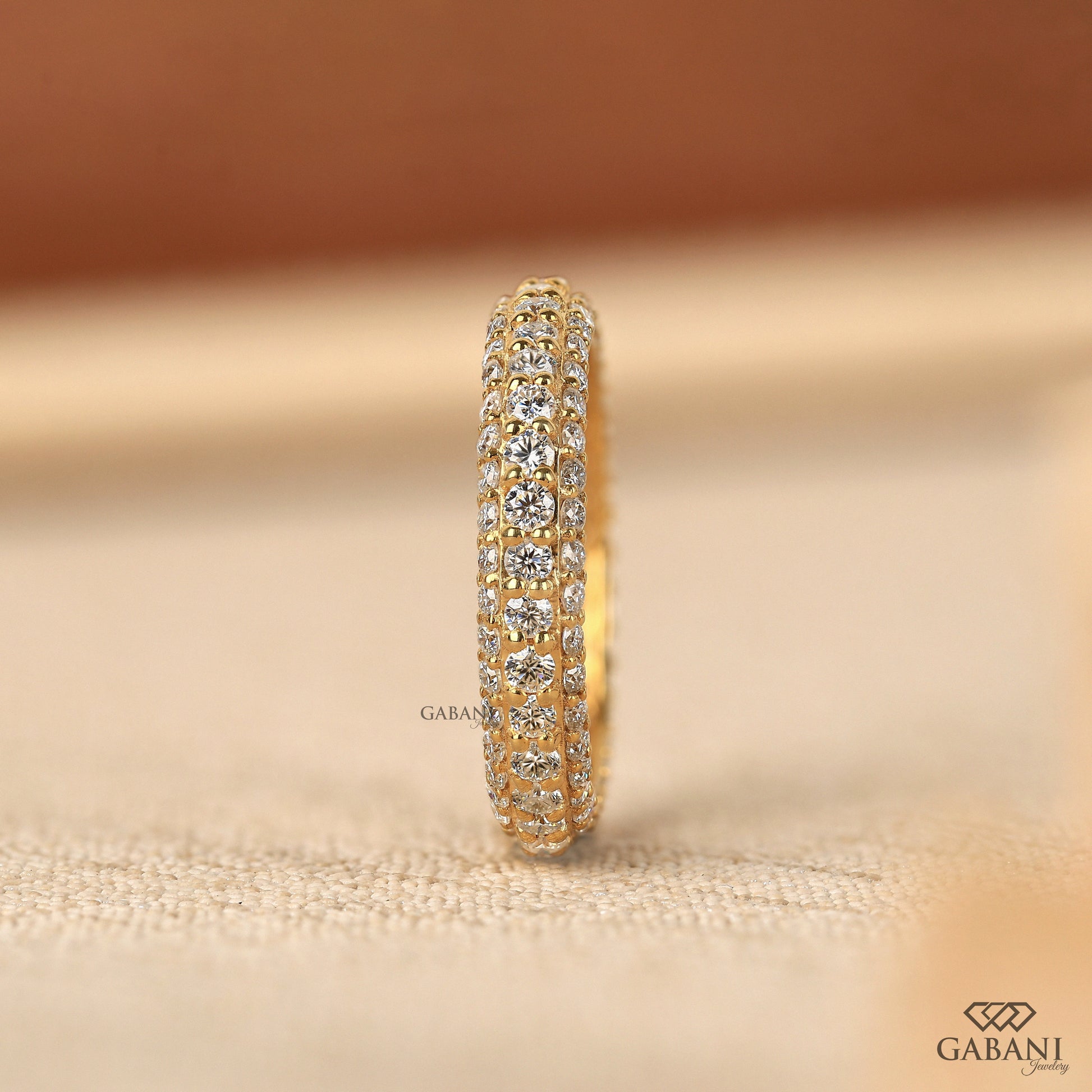 Three row pave wedding band with lab grown diamonds set closely in a micro pave design and warm metal tone for a bold matching look