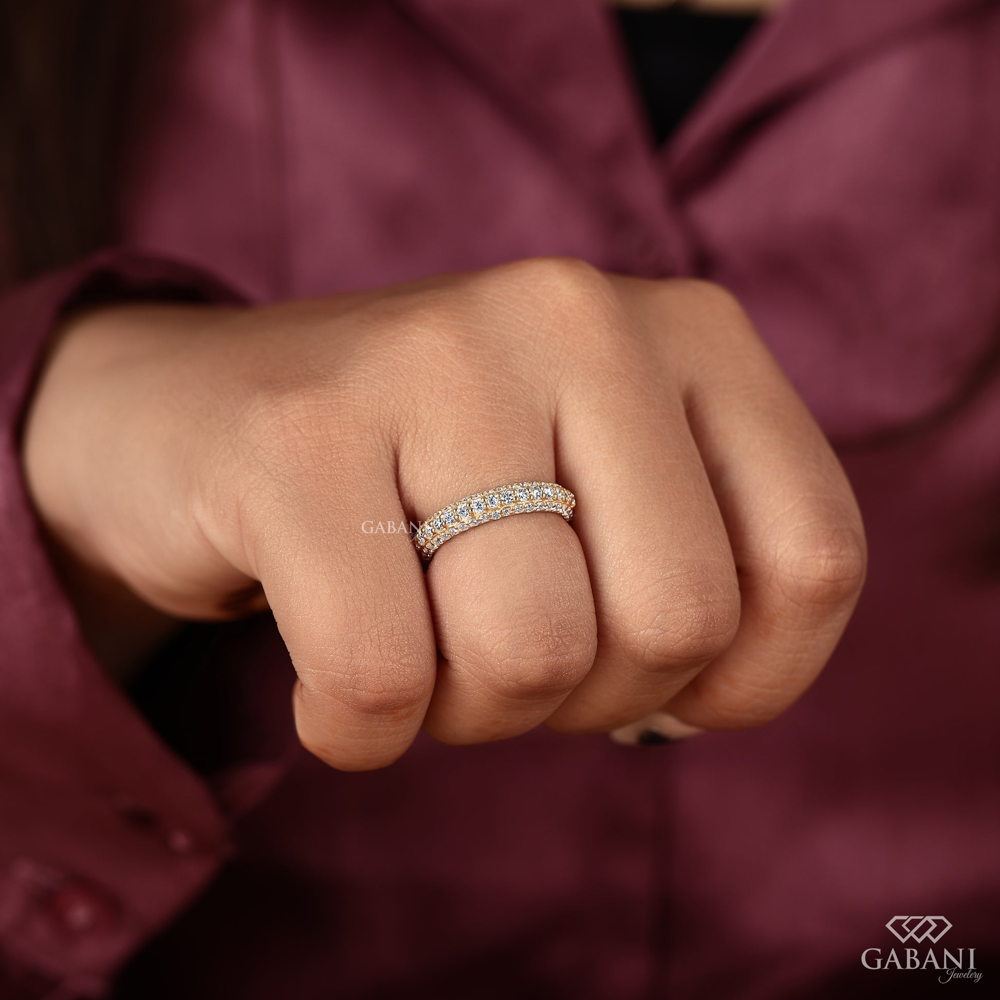 Lab grown diamond eternity style wedding band with a three row micro pave design and warm metal tone