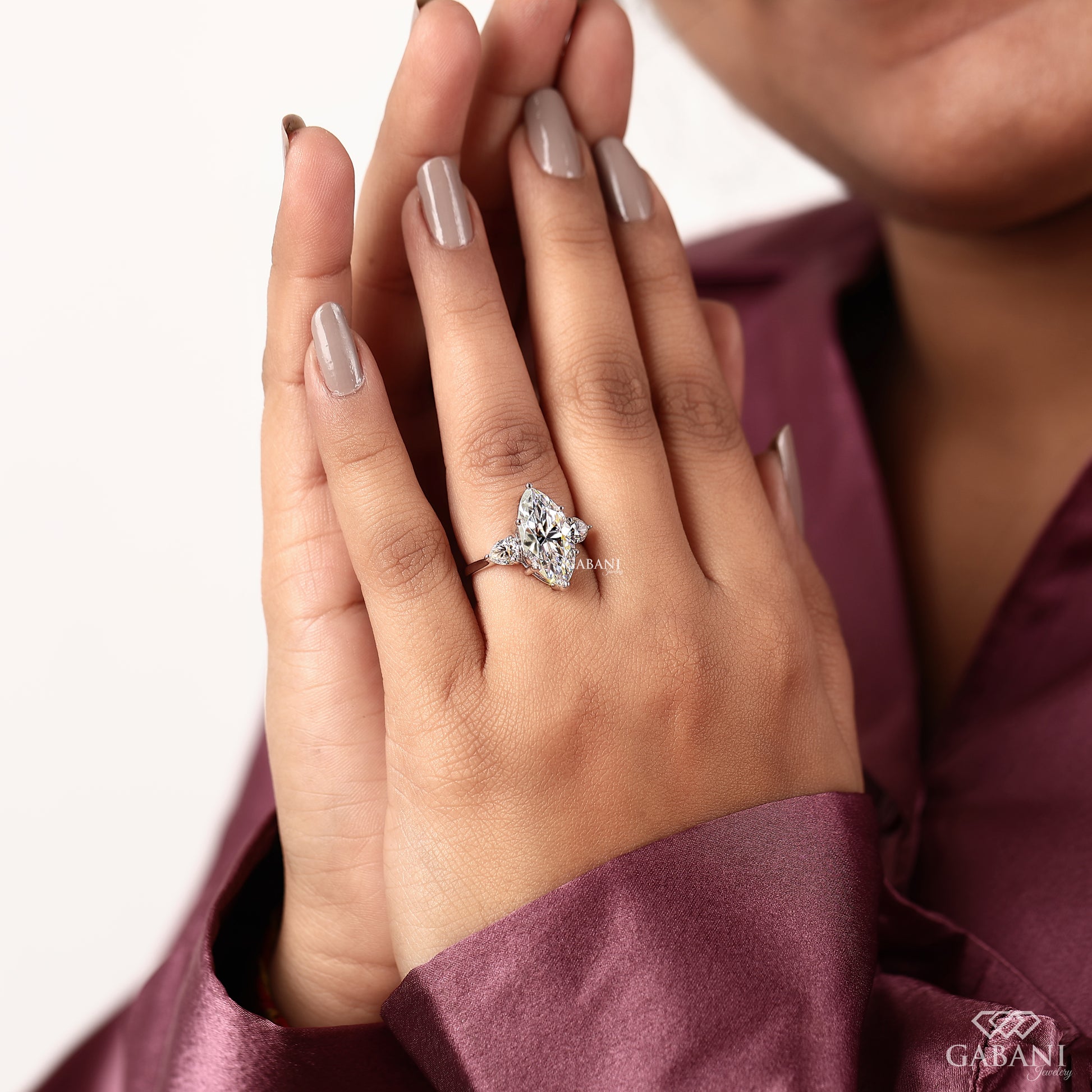 Lab grown diamond engagement ring with elongated marquise center and pear side stones in 18K gold