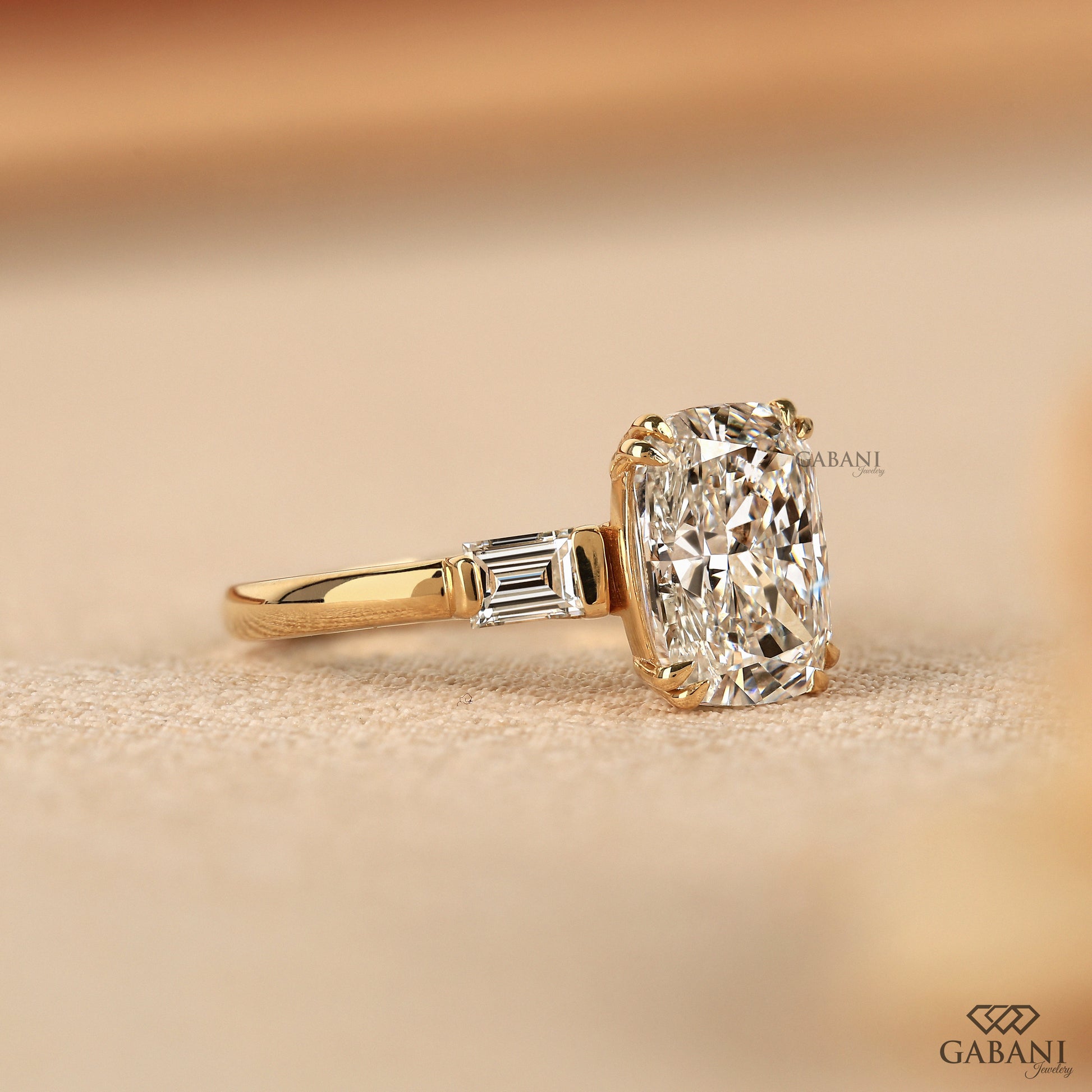 Solid yellow gold engagement ring featuring elongated cushion cut lab diamond