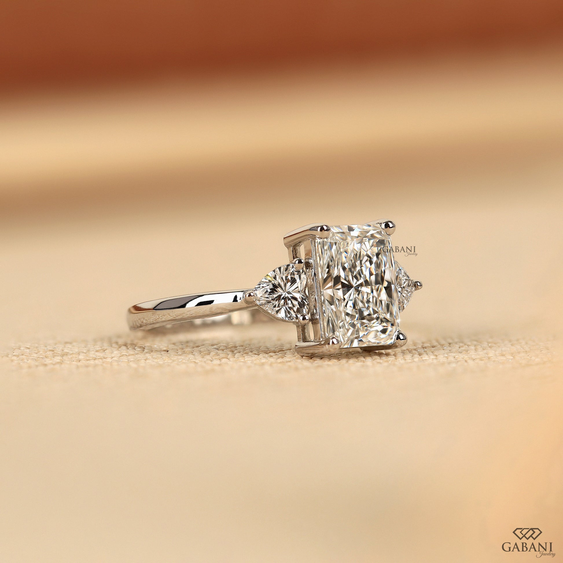 Radiant cut lab grown diamond ring in white gold with romantic heart side stones