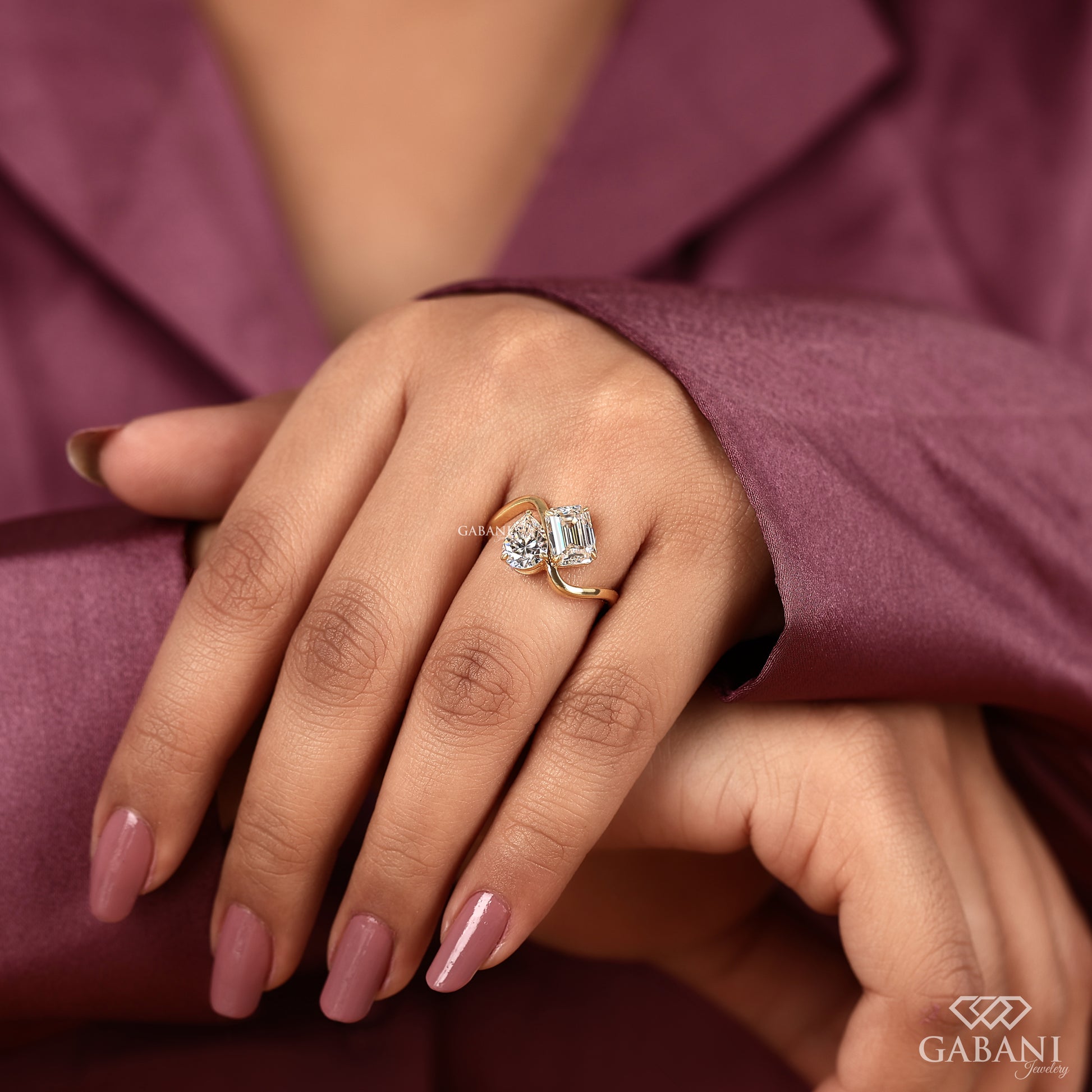 emerald and pear lab grown diamond ring in yellow gold with a refined cross band shank