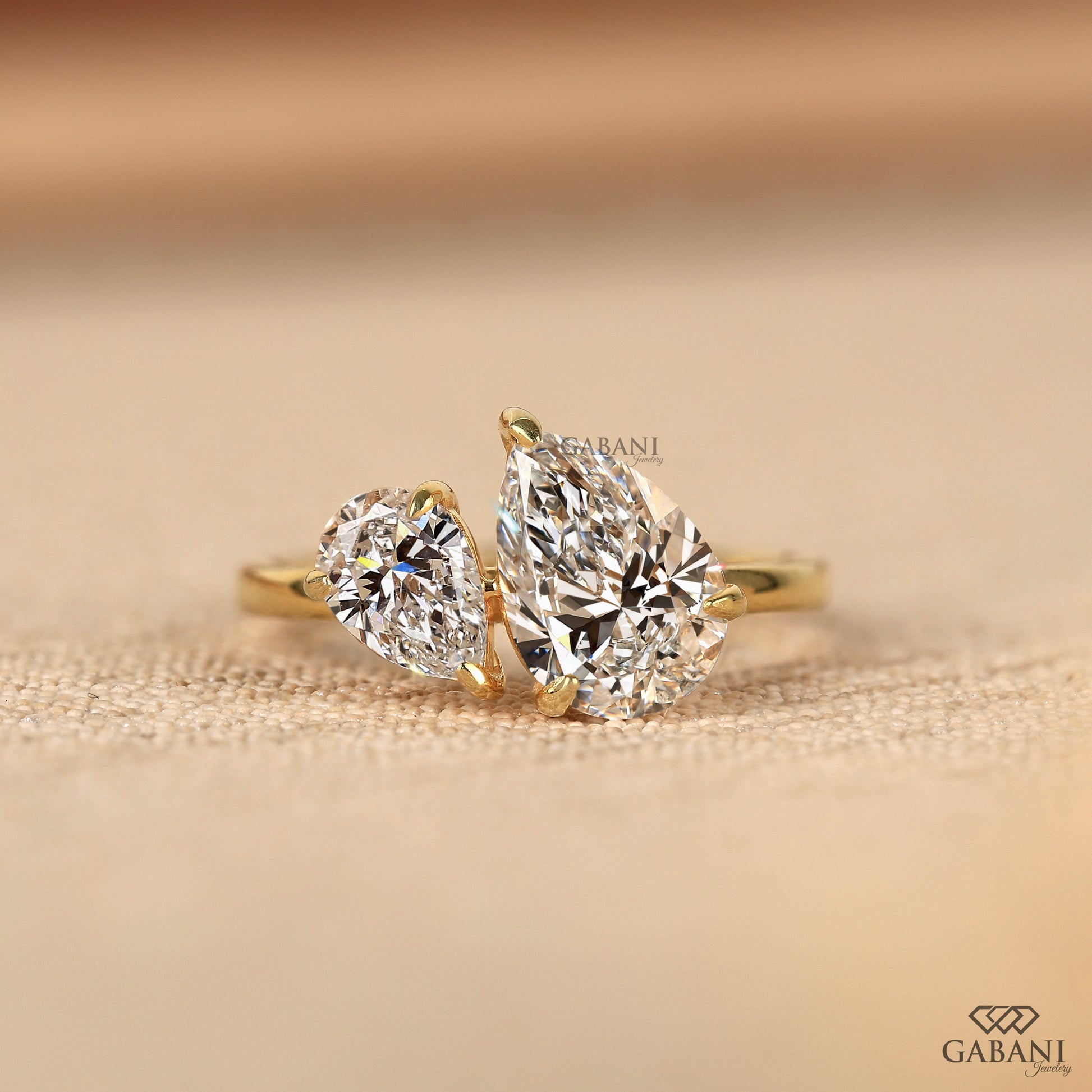 toi et moi ring with two pear shaped lab grown diamonds set side by side in solid yellow gold