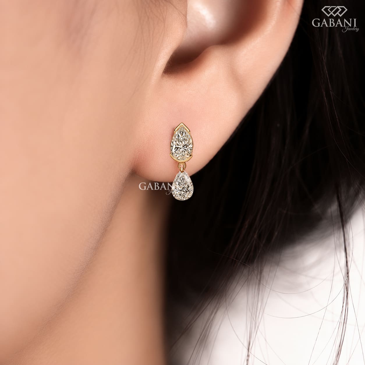 pear cut lab grown diamond drop earrings in yellow gold, featuring two sparkling pear-shaped diamonds on each earring in an elegant double teardrop design by Gabani Jewelry.
