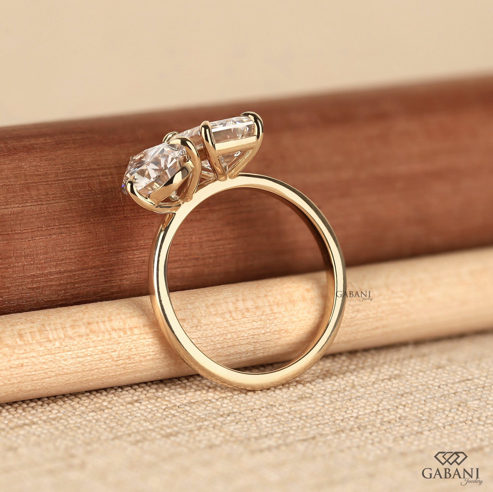 Handmade Toi et Moi lab grown diamond ring with emerald and pear cuts in polished gold finish