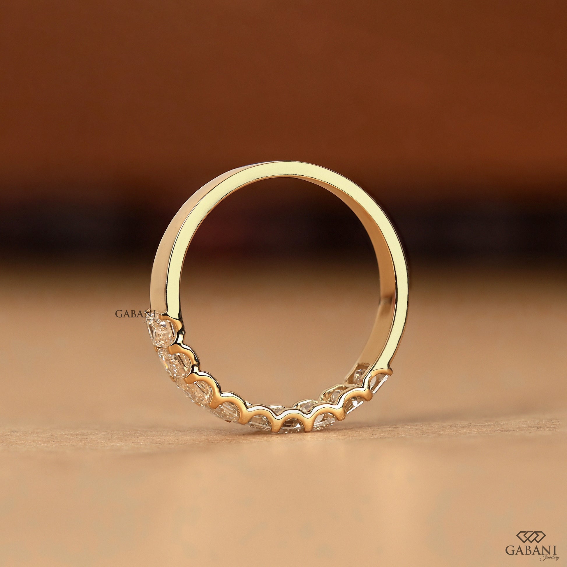 yellow gold emerald cut lab grown diamond ring with 9 stones in sleek half eternity band

