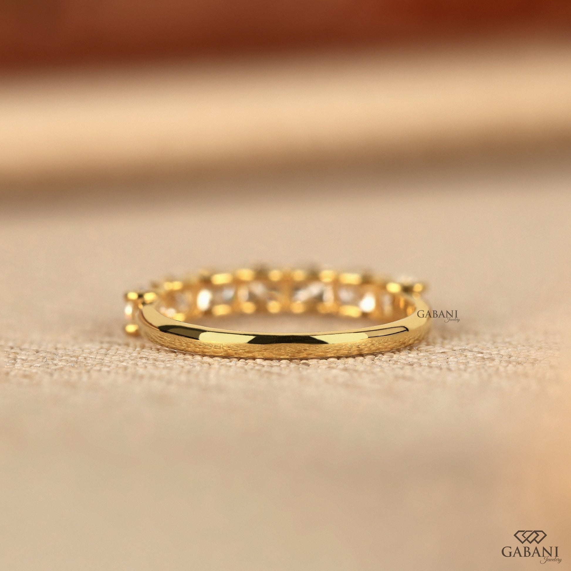 yellow gold band with cushion cut lab created diamonds in a clean u prong design