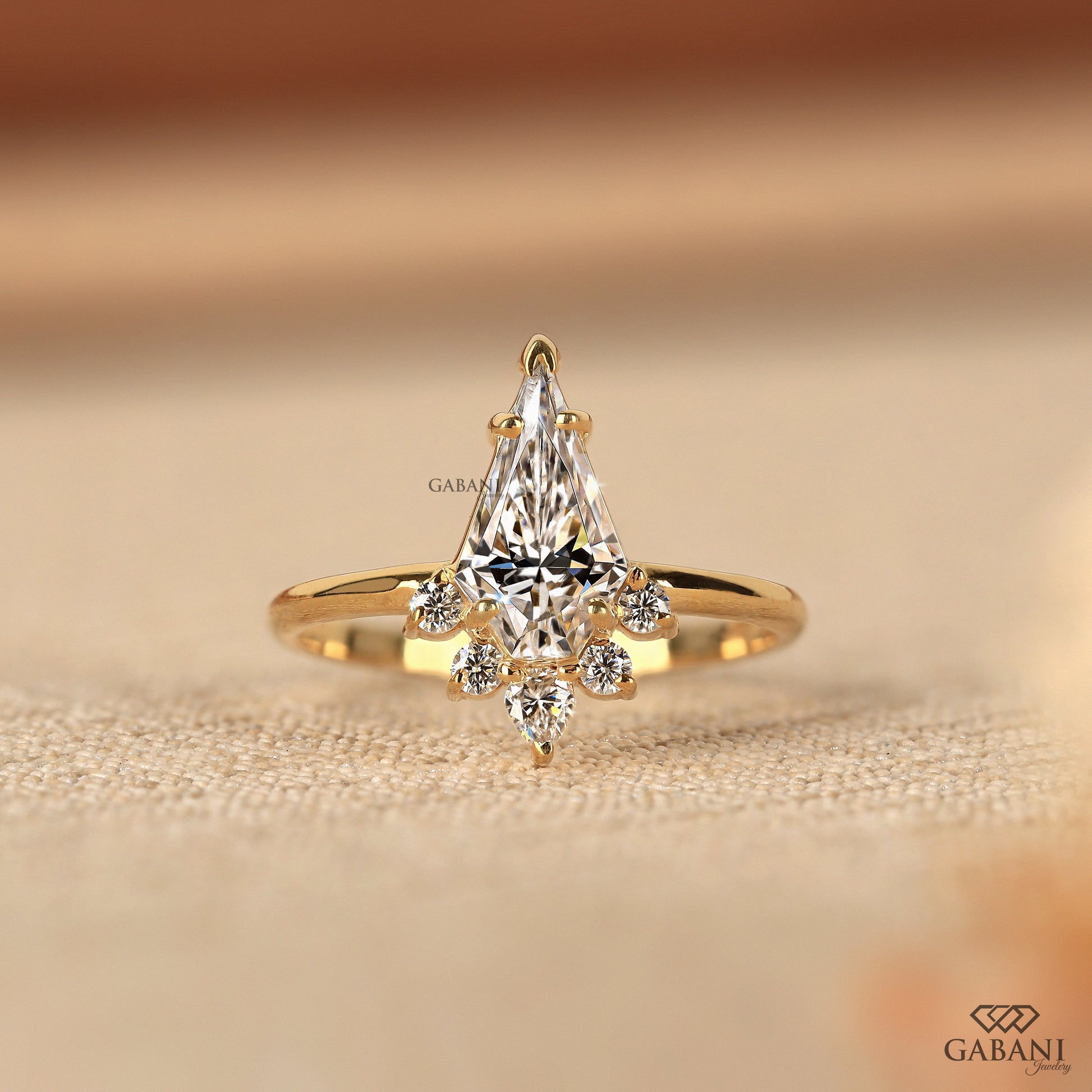 vintage engagement ring with kite cut lab grown diamond and round pear accents in yellow gold