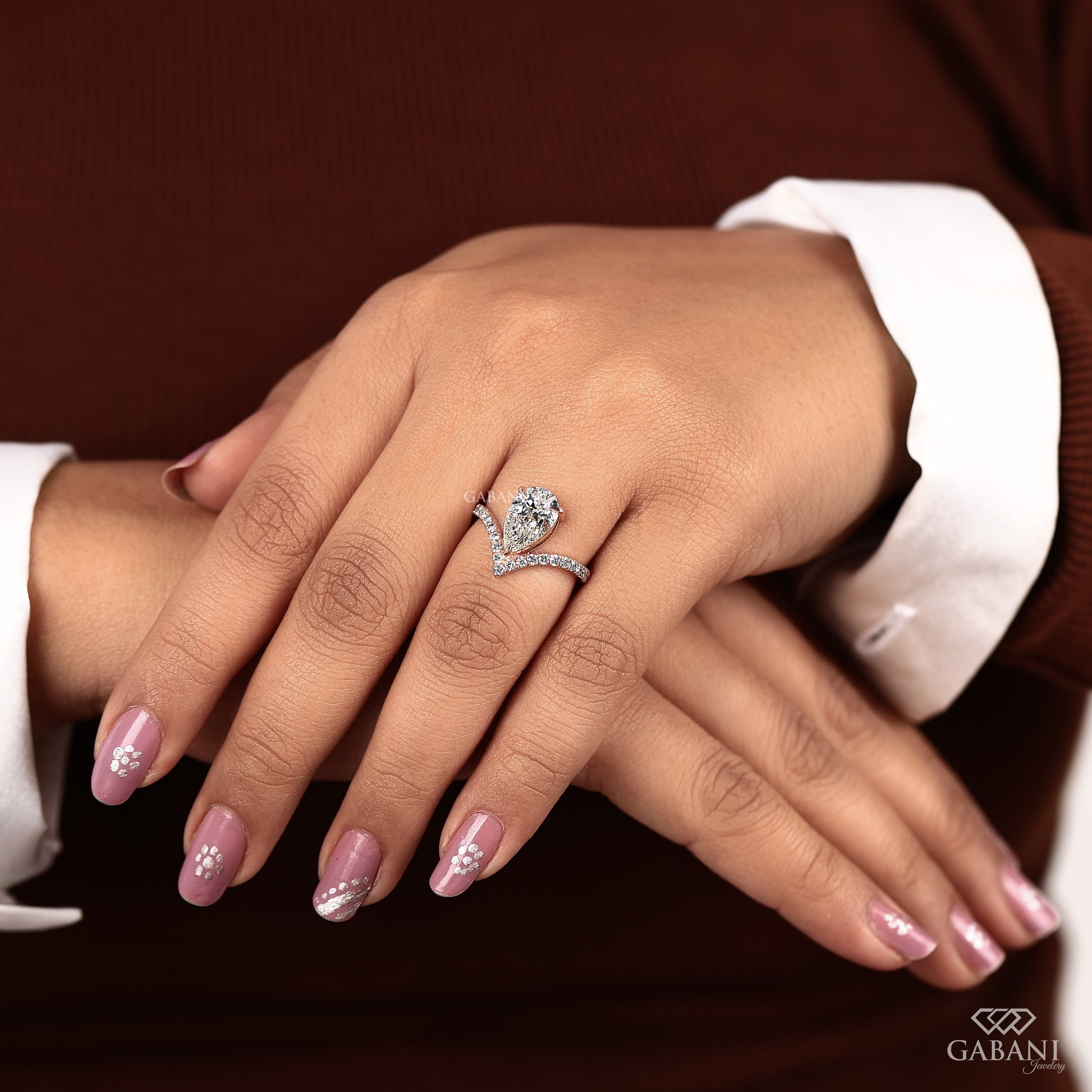 Rose gold engagement ring with pear cut lab created diamond and pavé band