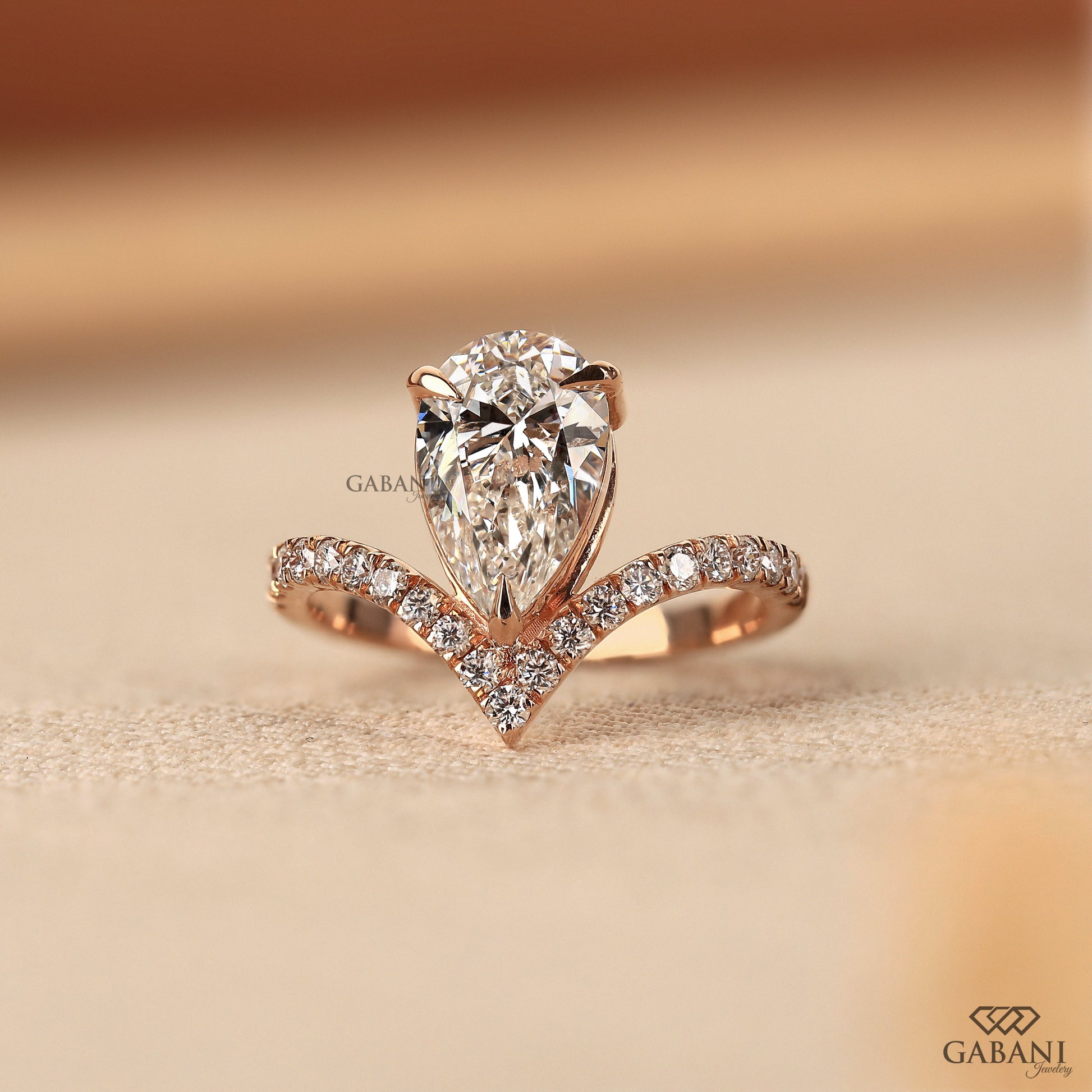 Pear shaped lab created diamond engagement ring in V setting