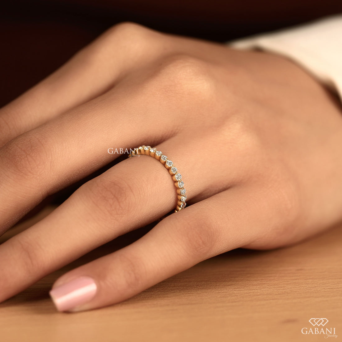 Round cut lab grown diamond bezel set eternity wedding band in solid yellow gold, stackable bridal and anniversary ring.