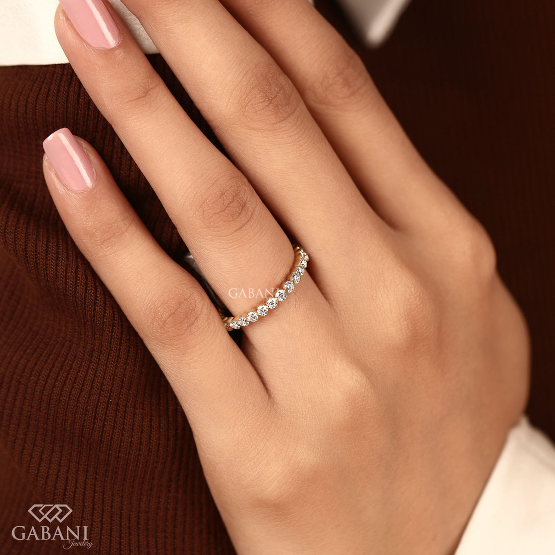 Round cut lab grown diamond full eternity wedding band in yellow gold with shared prong setting and continuous diamond design.