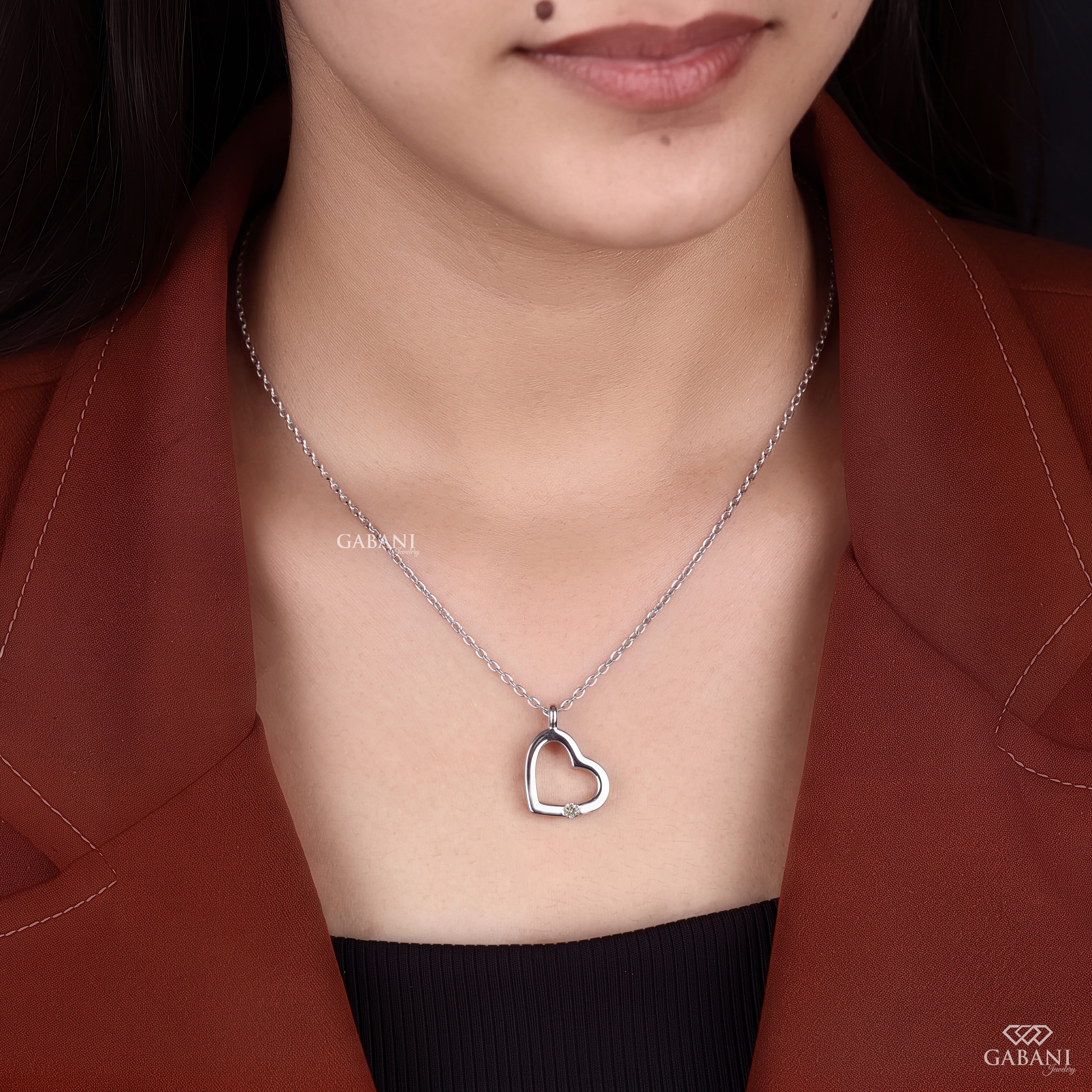Open heart lab grown diamond pendant necklace in polished white gold featuring a single round cut diamond accent and delicate link chain.