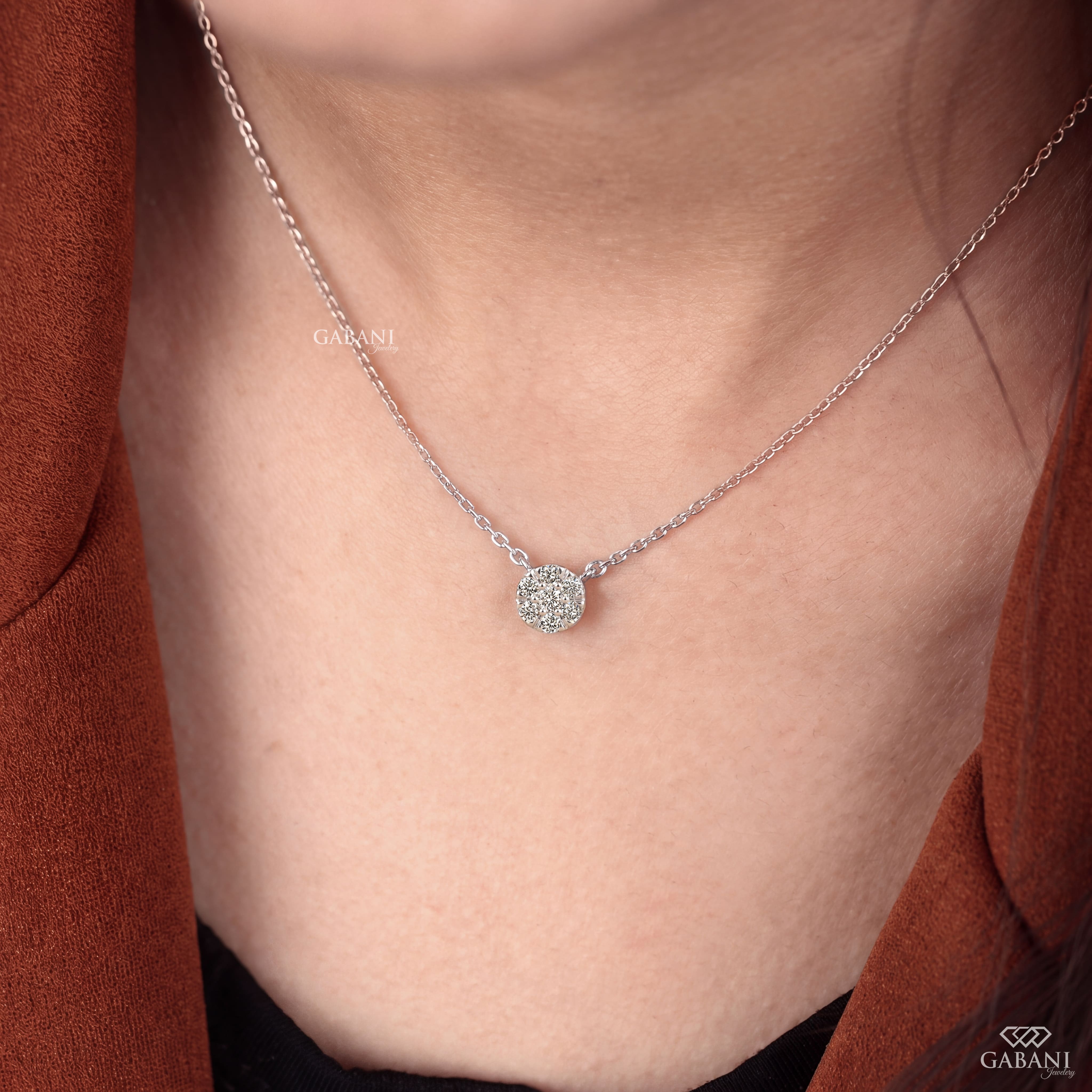 Seven stone round cut lab grown diamond floral cluster necklace in 18K white gold with a delicate cable chain and prong setting.