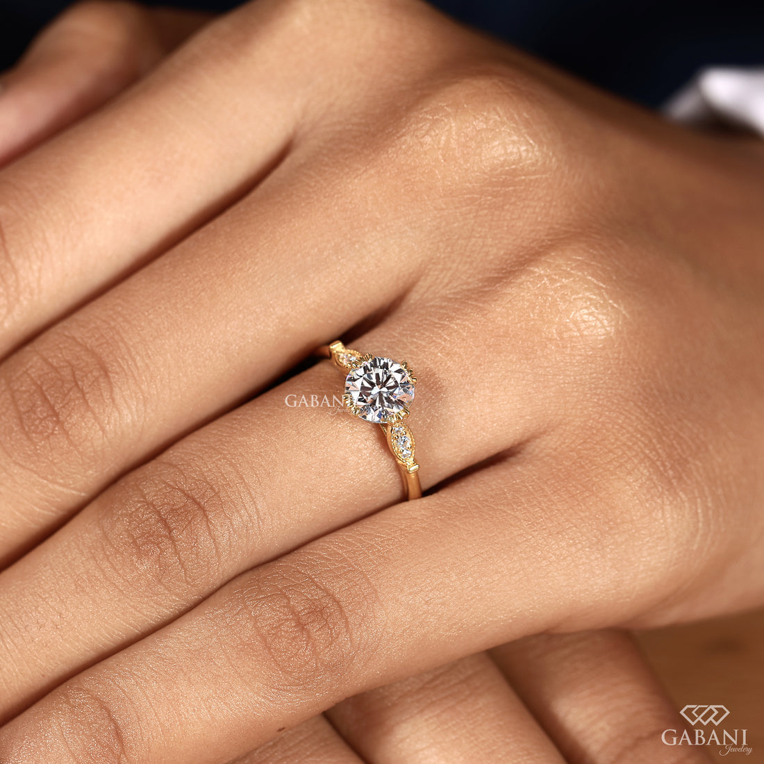 Model wearing round brilliant lab grown diamond engagement ring with milgrain side diamonds