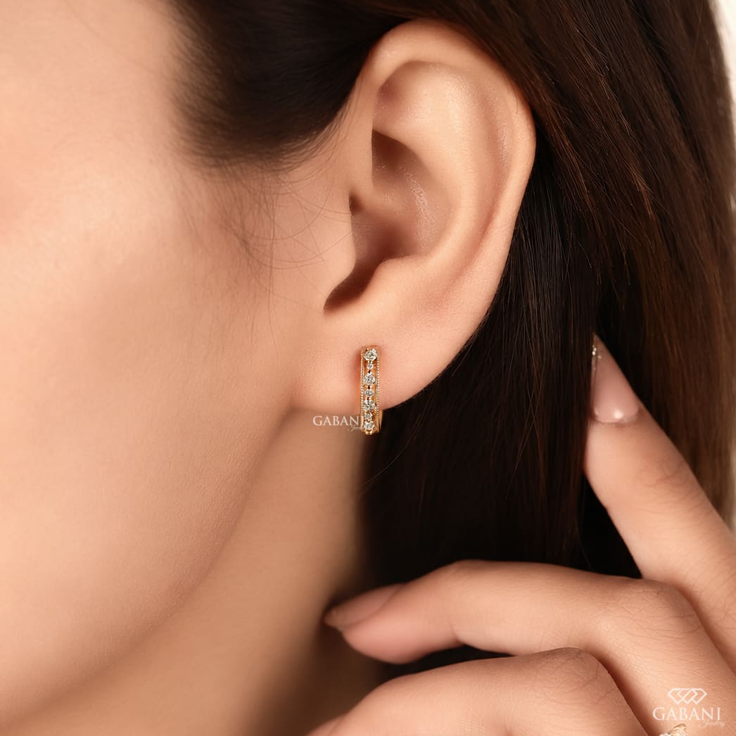 Round cut diamond milgrain hoop earrings in yellow gold with graduated diamonds