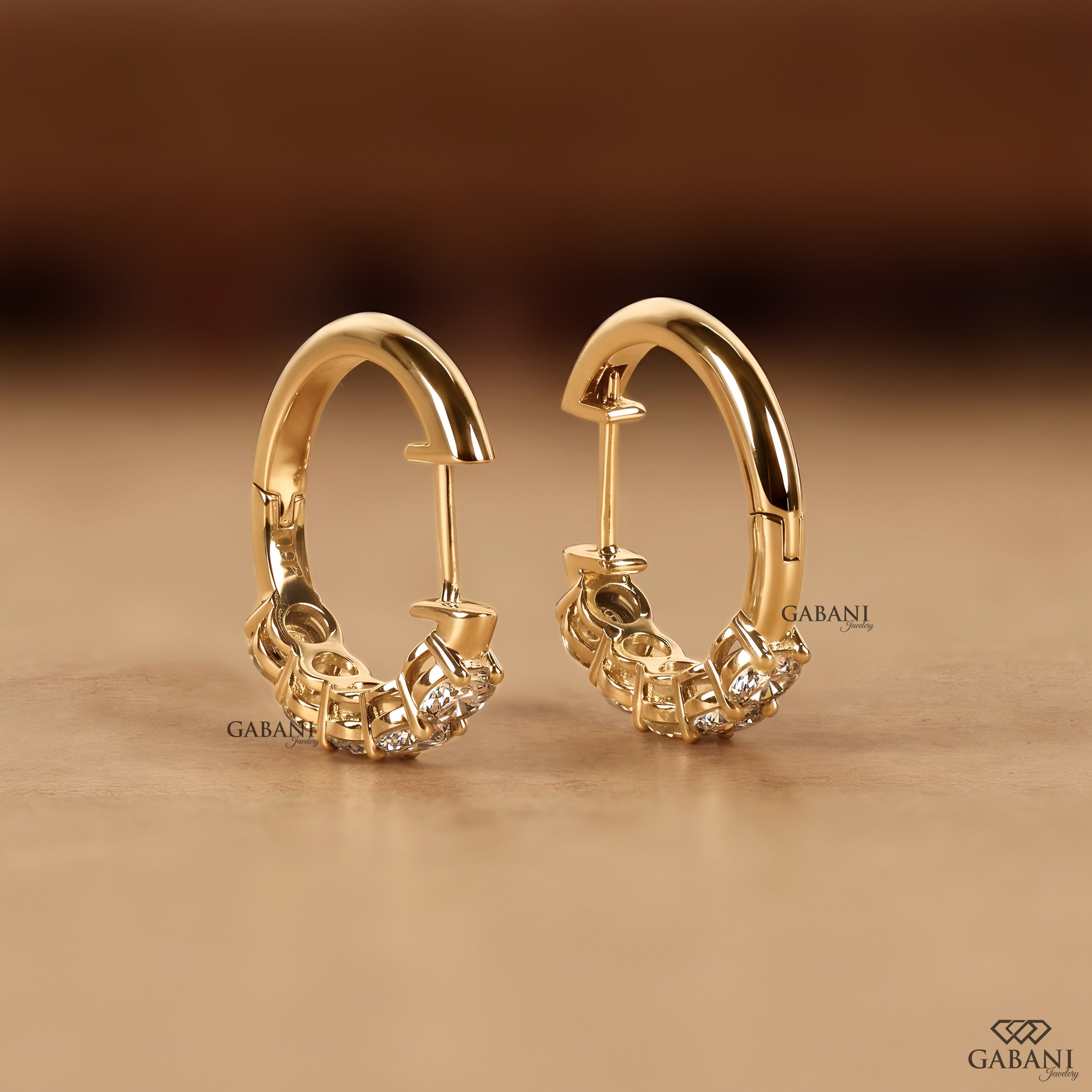 Yellow gold huggie earrings set with round cut lab grown diamonds