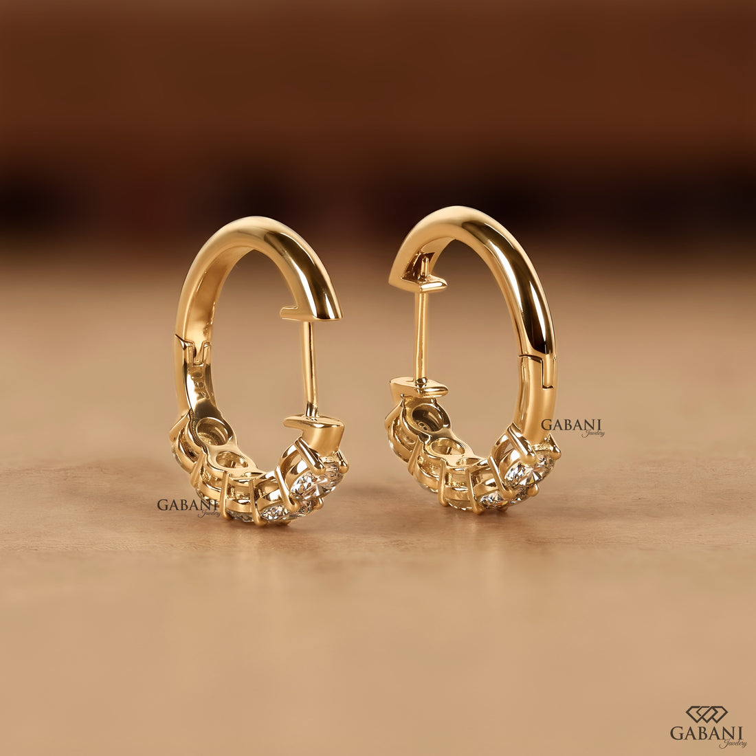 Yellow gold huggie earrings set with round cut lab grown diamonds