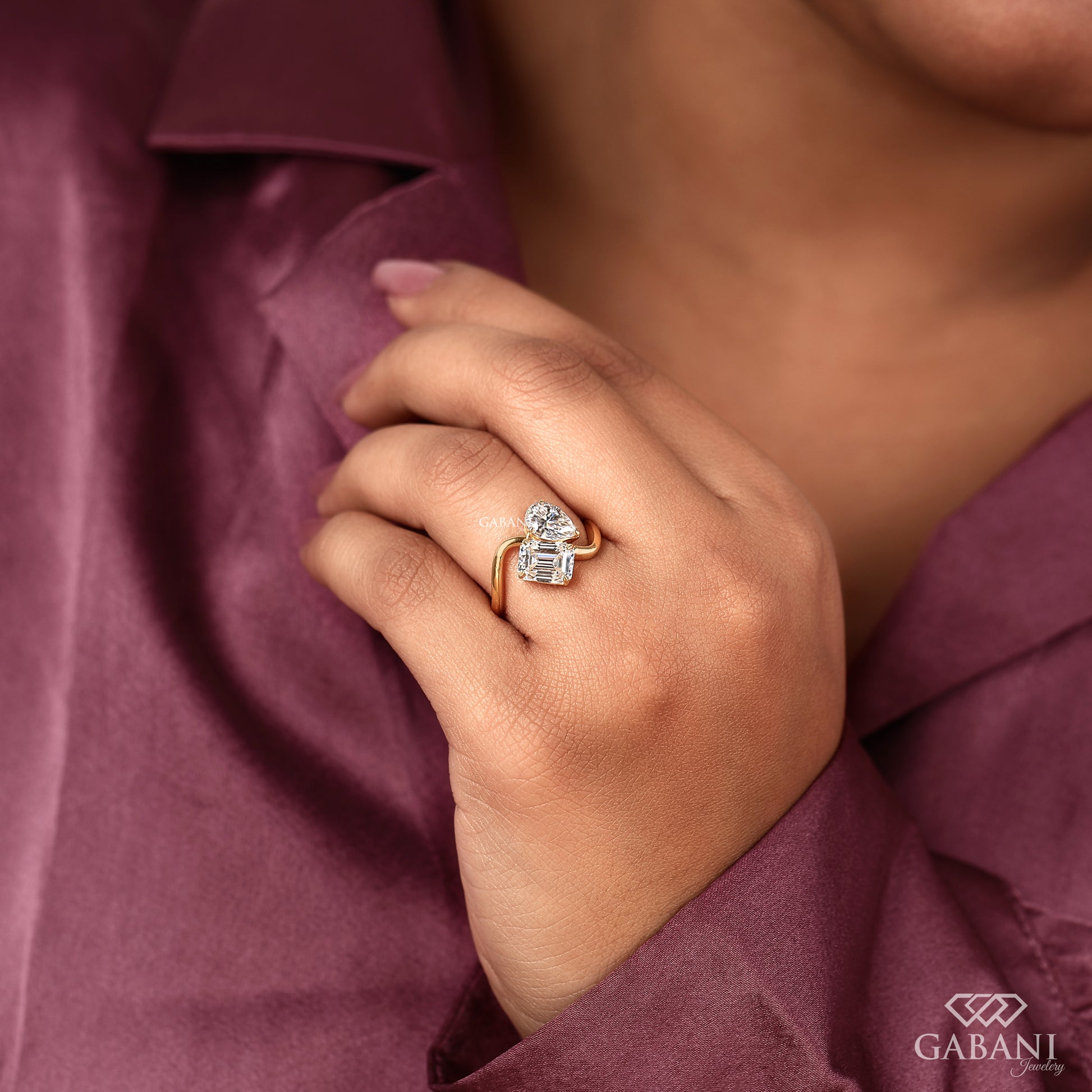 toi et moi ring showcasing emerald and teardrop lab grown diamonds in yellow gold prong setting